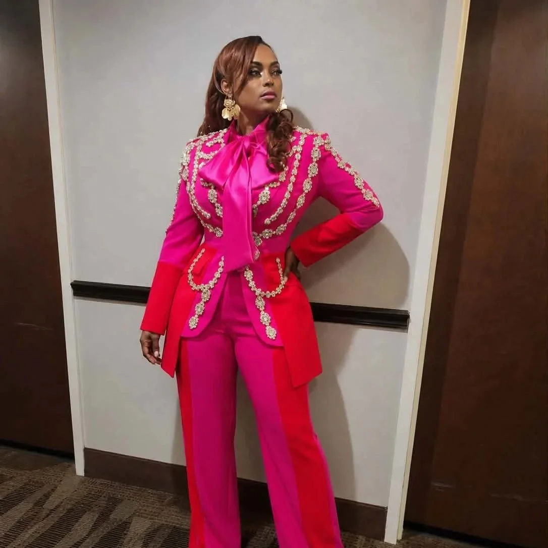 CEO Queen rocking the pink and red Paint suit