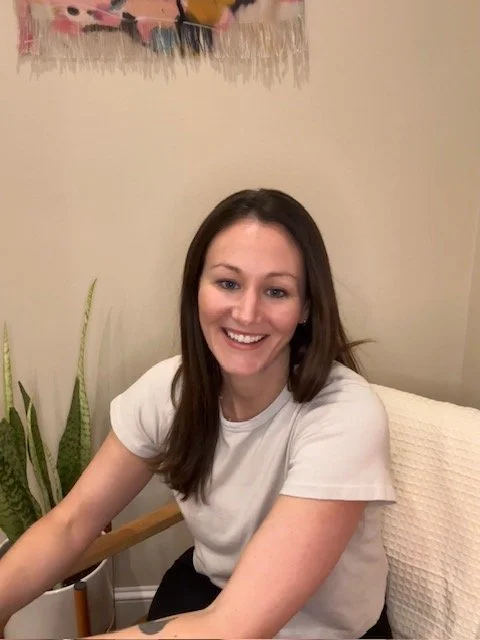 Licensed Massage Therapist in her Falmouth, Maine treatment room, with a plant, blanket and warm atmosphere