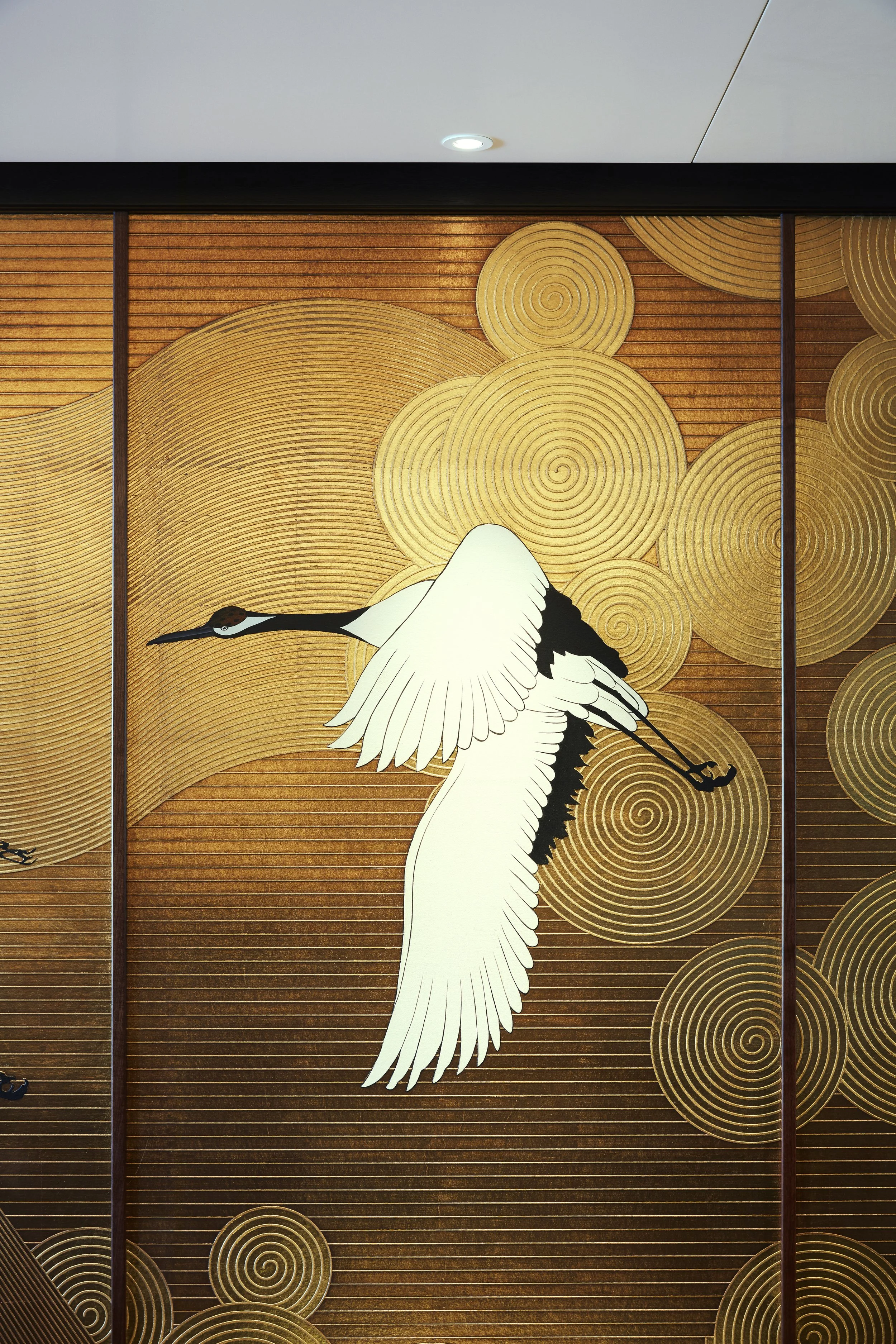 Japanese-style wall art with a crane in flight and geometric patterns