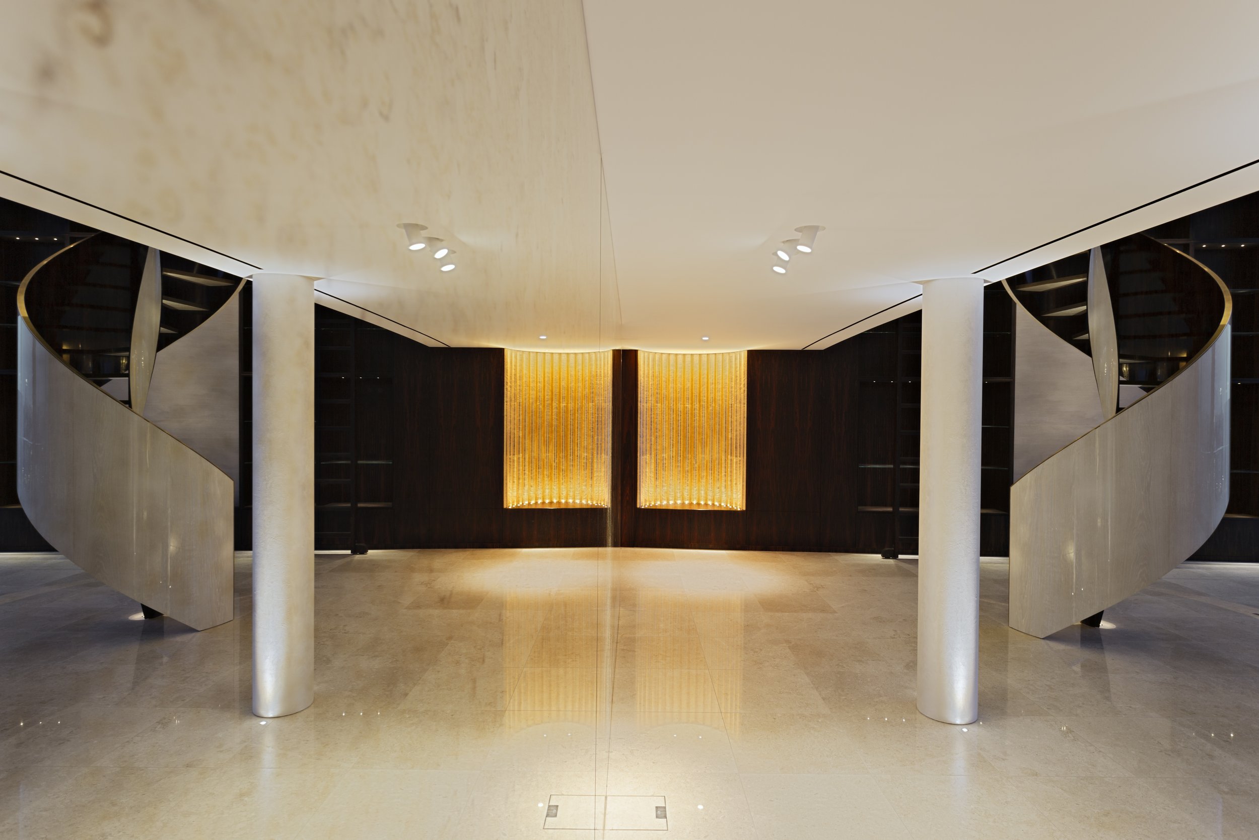modern interior with spiral staircase and illuminated wall