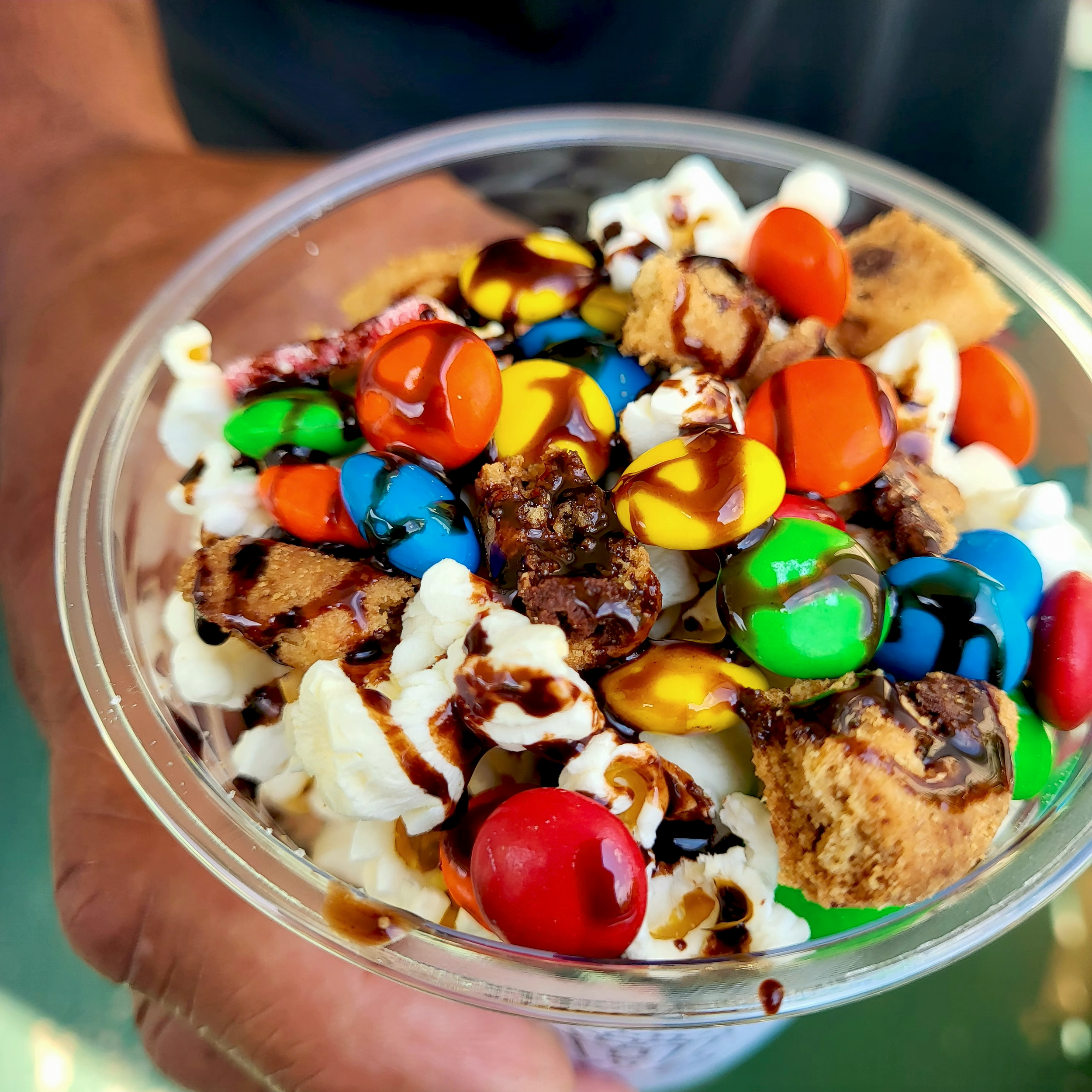 Popcorn bar toppings including candy, cookies, and seasonings