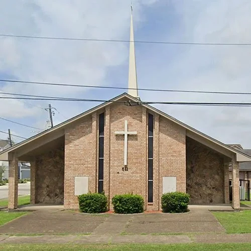 Silhouette of a soldier saluting against an American flag overlay and a sunset sky.