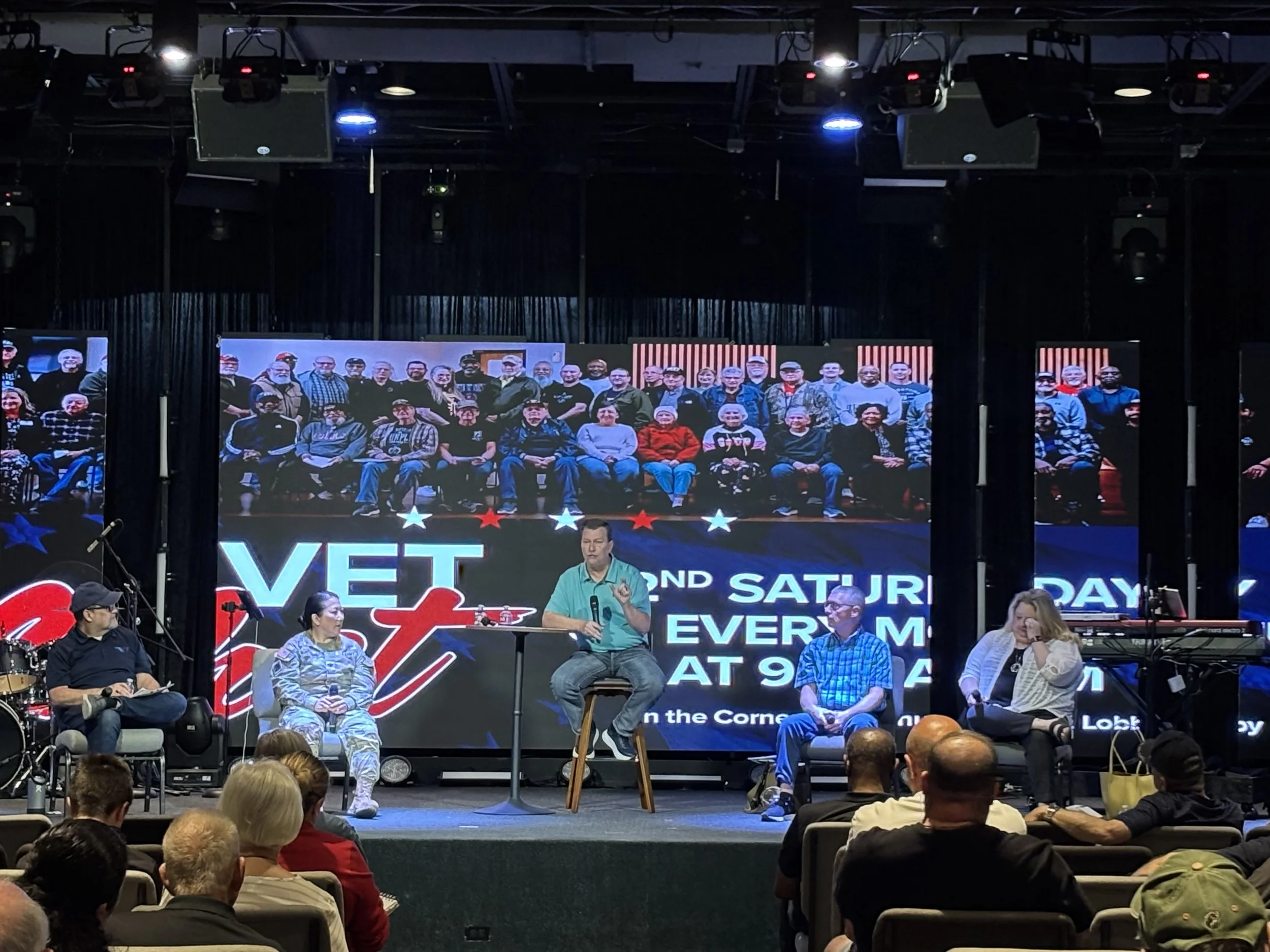 Close-up of hands holding coffee cups during a casual conversation.