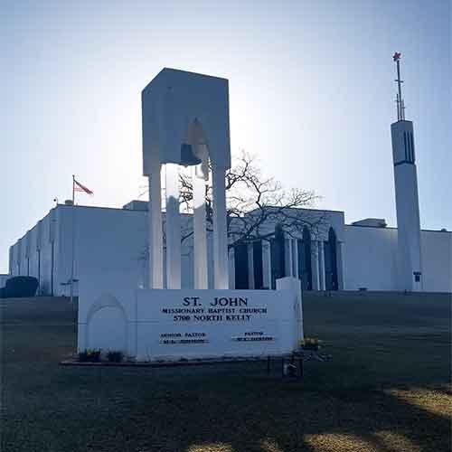 Silhouette of a soldier saluting against an American flag overlay and a sunset sky.