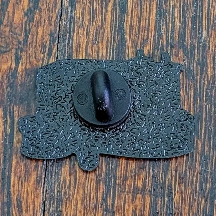 Back of the Make Me Melt soft enamel pin with metal post and black rubber backing