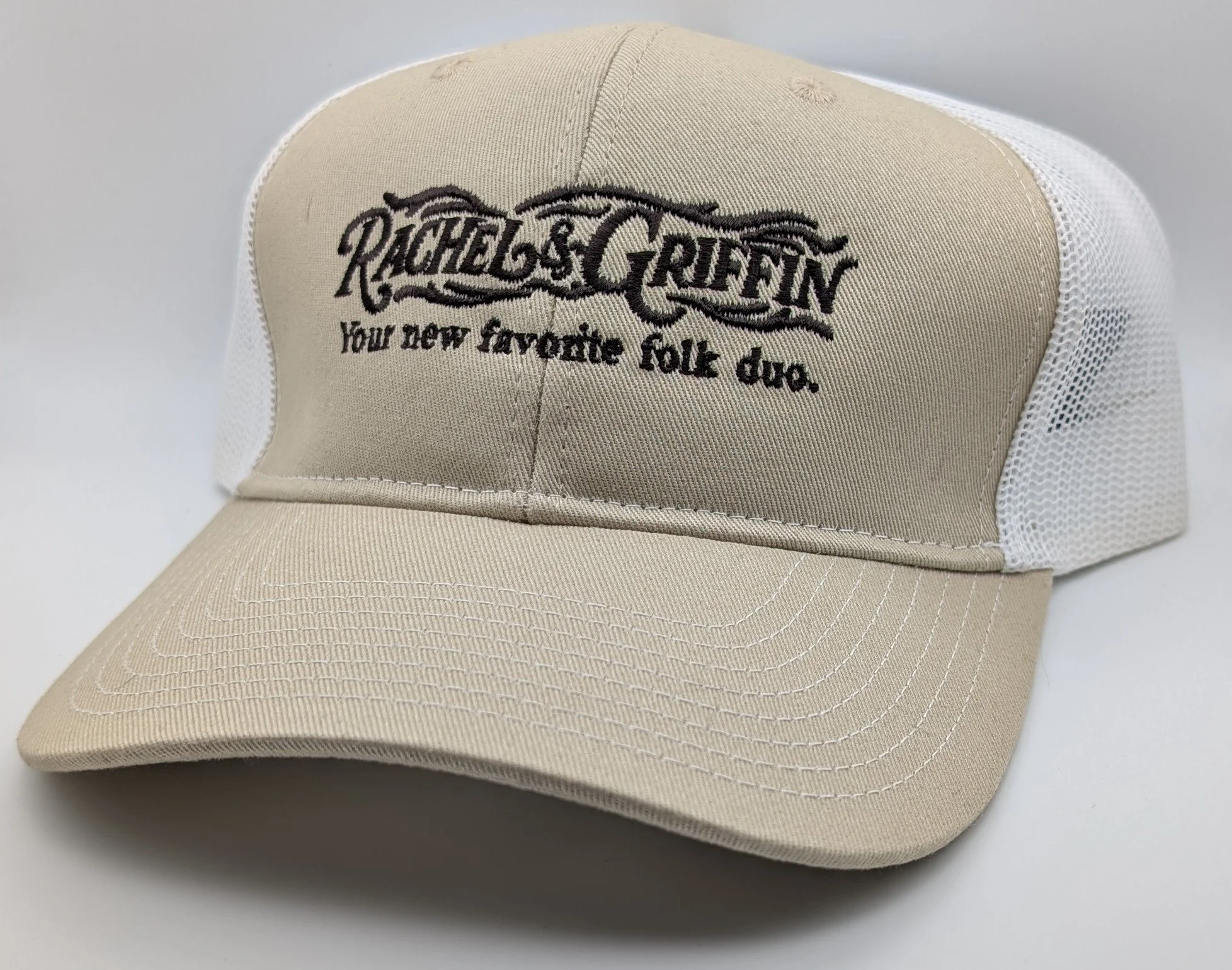 white and tan hat, brown stitching