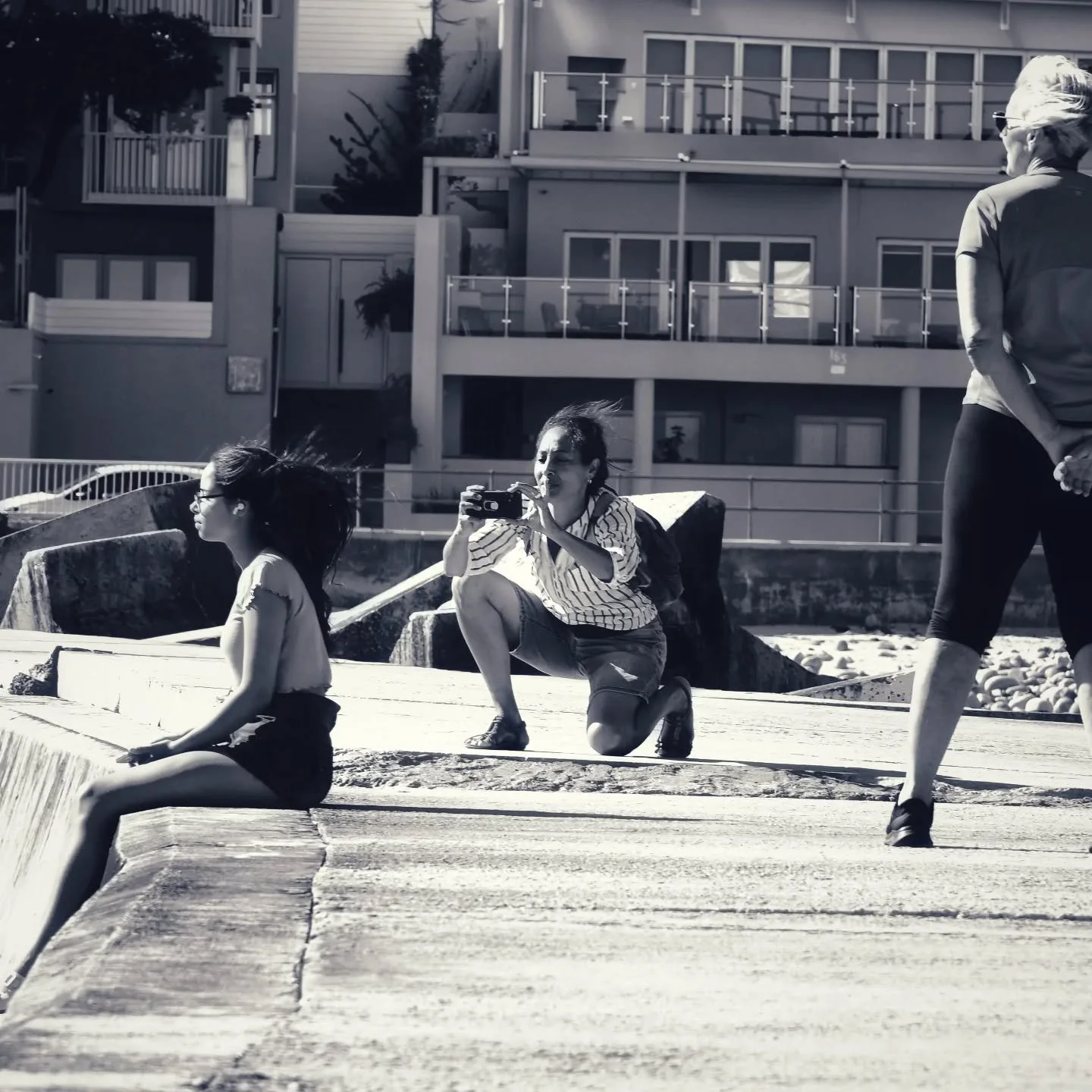 ​Three Ways of Seeing.
​A daughter lost in the horizon, a mother capturing the memory, and a friend standing watch.
​I loved how this "human triangle" formed naturally at Gordon's Bay&mdash;each person anchored in the same moment, but viewi