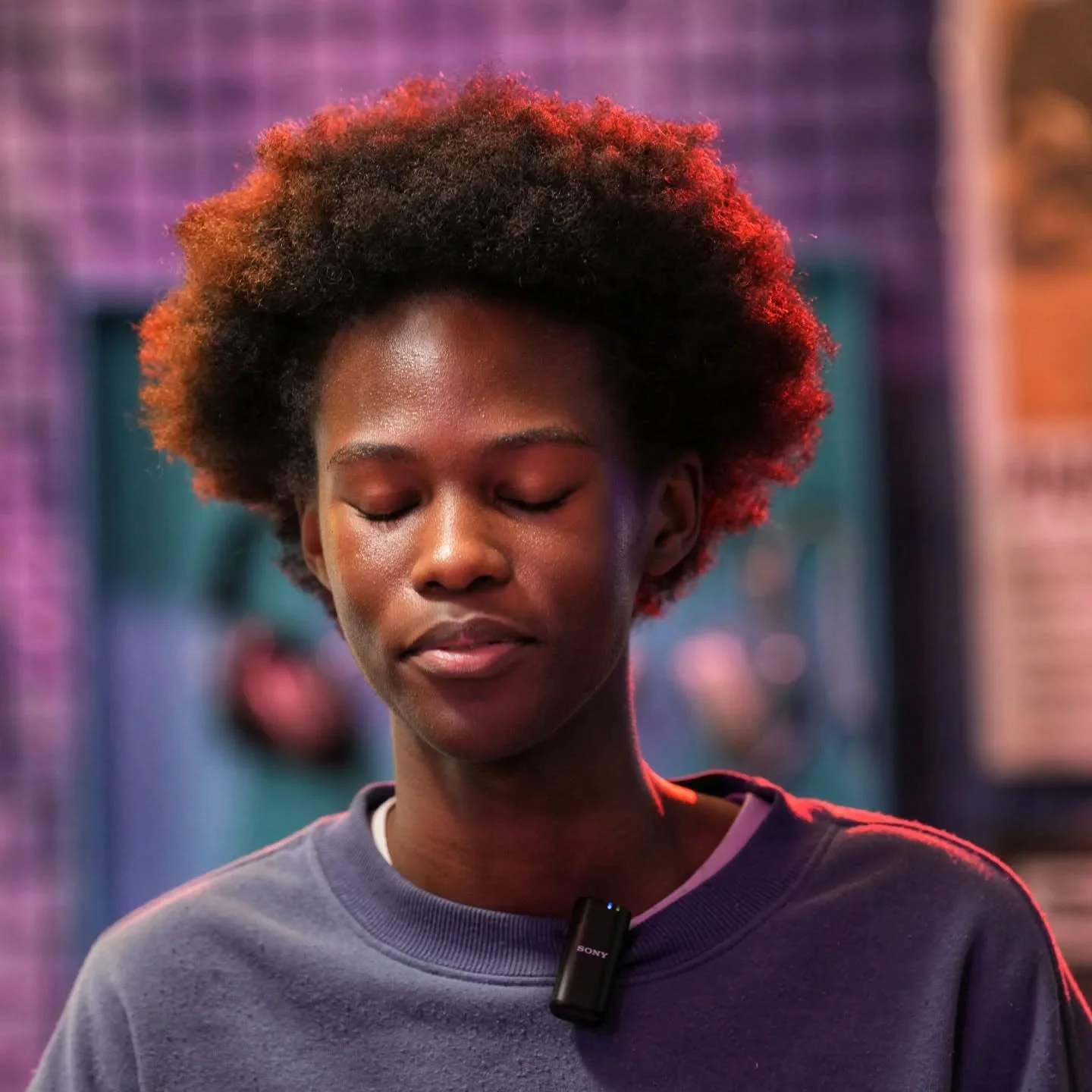 Between Shoulders

I was testing a Sony Alpha 7R with a FE 2/50&ndash;150 GE lens during a brand event when I noticed him.
At first, it was the hairstyle &mdash; the shape, the texture, the way the light caught it. I seized the moment and took a phot