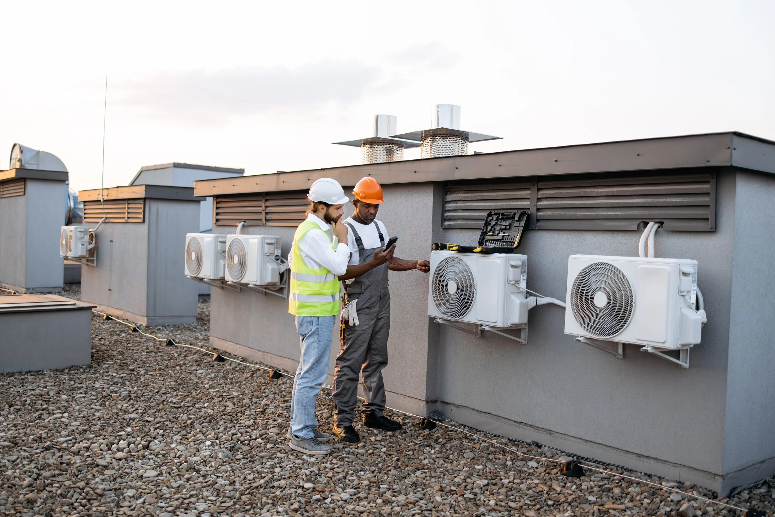 two-construction-workers-on-roof-inspecting-coolin-2024-12-13-03-10-55-utc.jpg