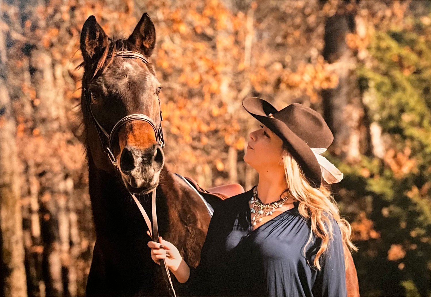 Natalie Conca, Masterson Method Equine Specialist walking with horse