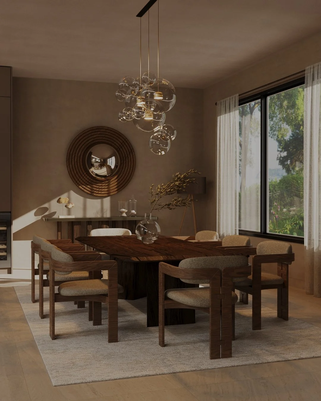 A modern dining room with a large wooden table surrounded by eight beige and wood dining chairs, a glass vase with branches on the table, a beige rug, large window with sheer white curtains, and a contemporary chandelier with glass globes hanging abo