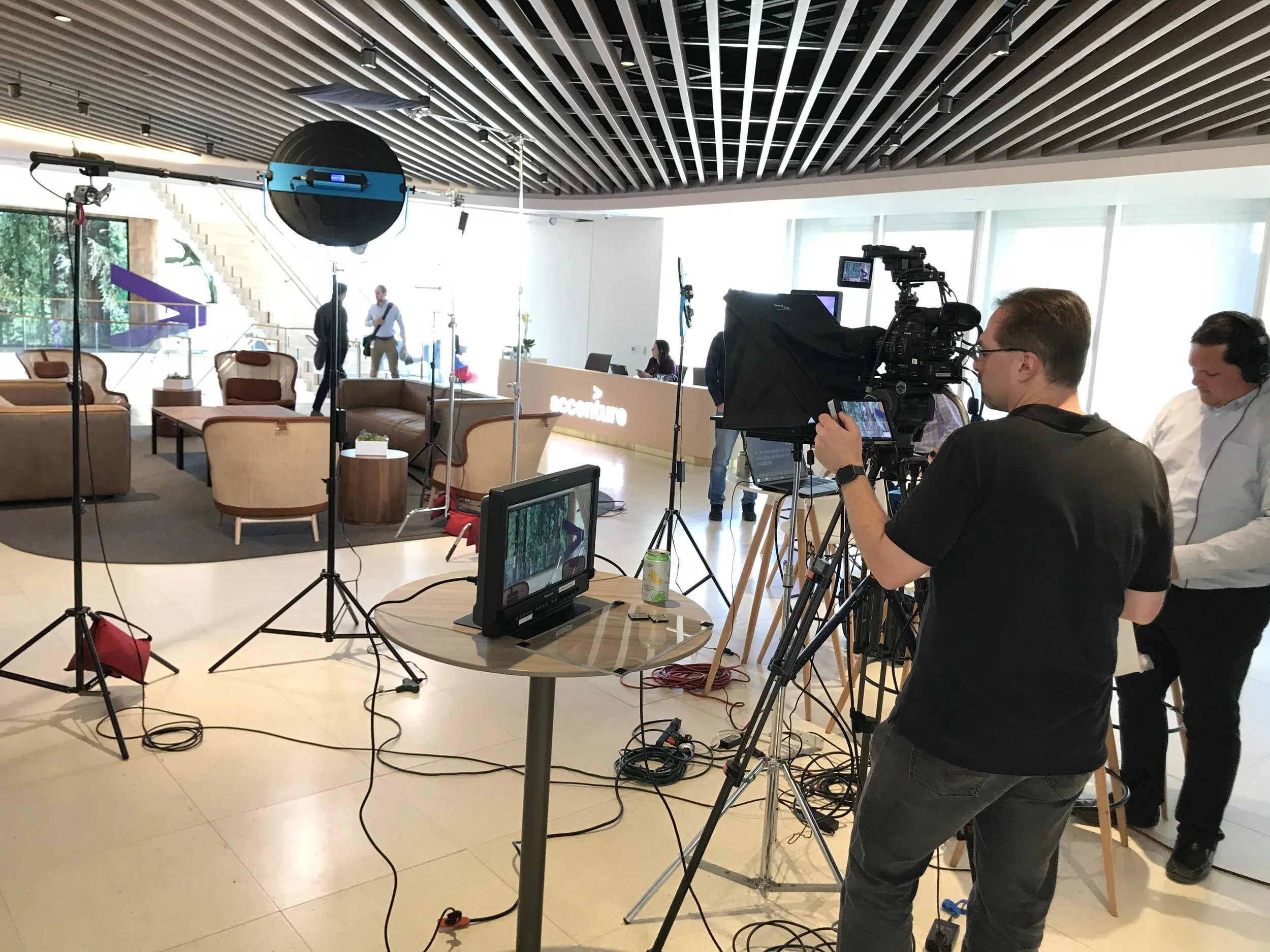 Camera set up with teleprompter in front of camera and tripod.