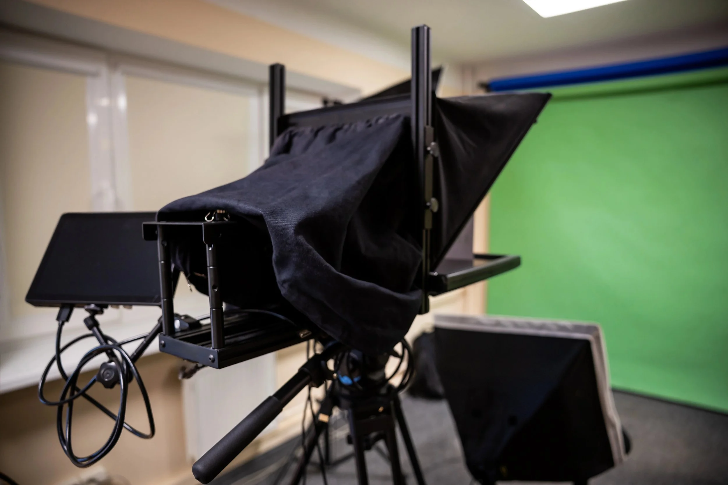 Photography studio with professional camera and onboard tripod teleprompter..