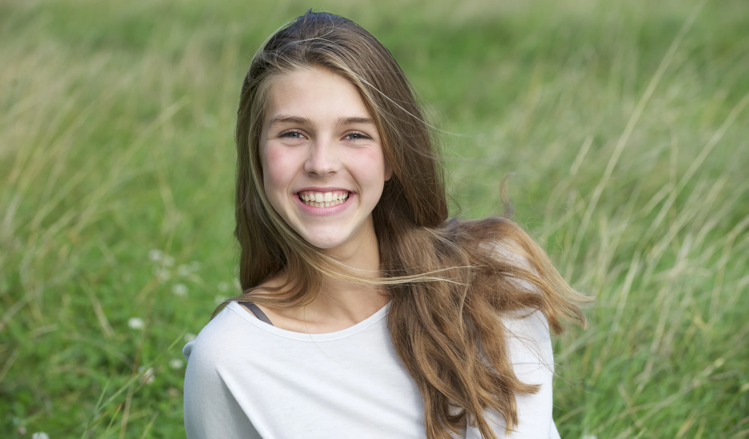 girlsmilingongrass.jpg