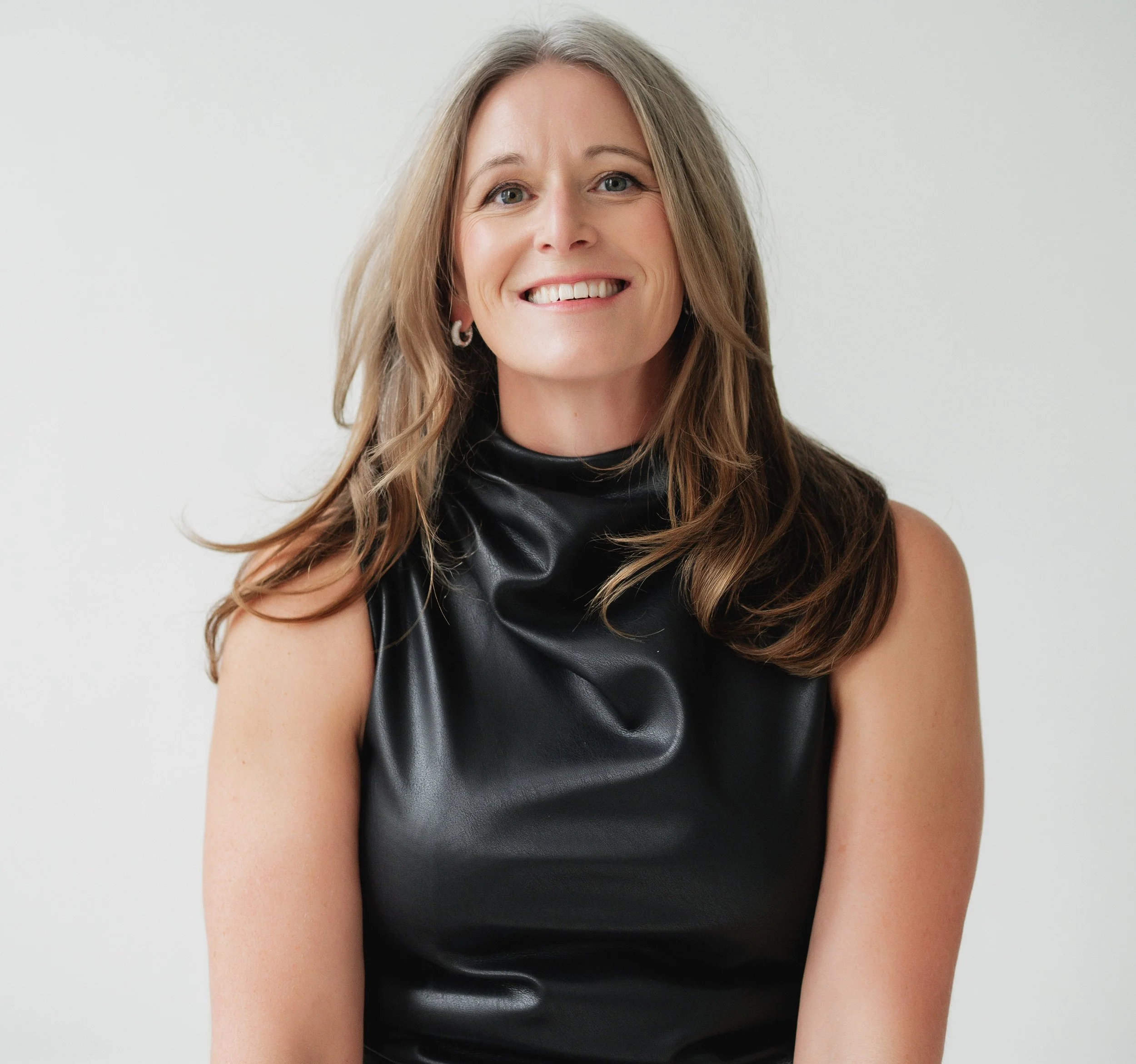 Separation and divorce coach Lana Wickstrom in Saskatoon is wearing a black sleeveless top with a leather-like finish, against a plain light background.