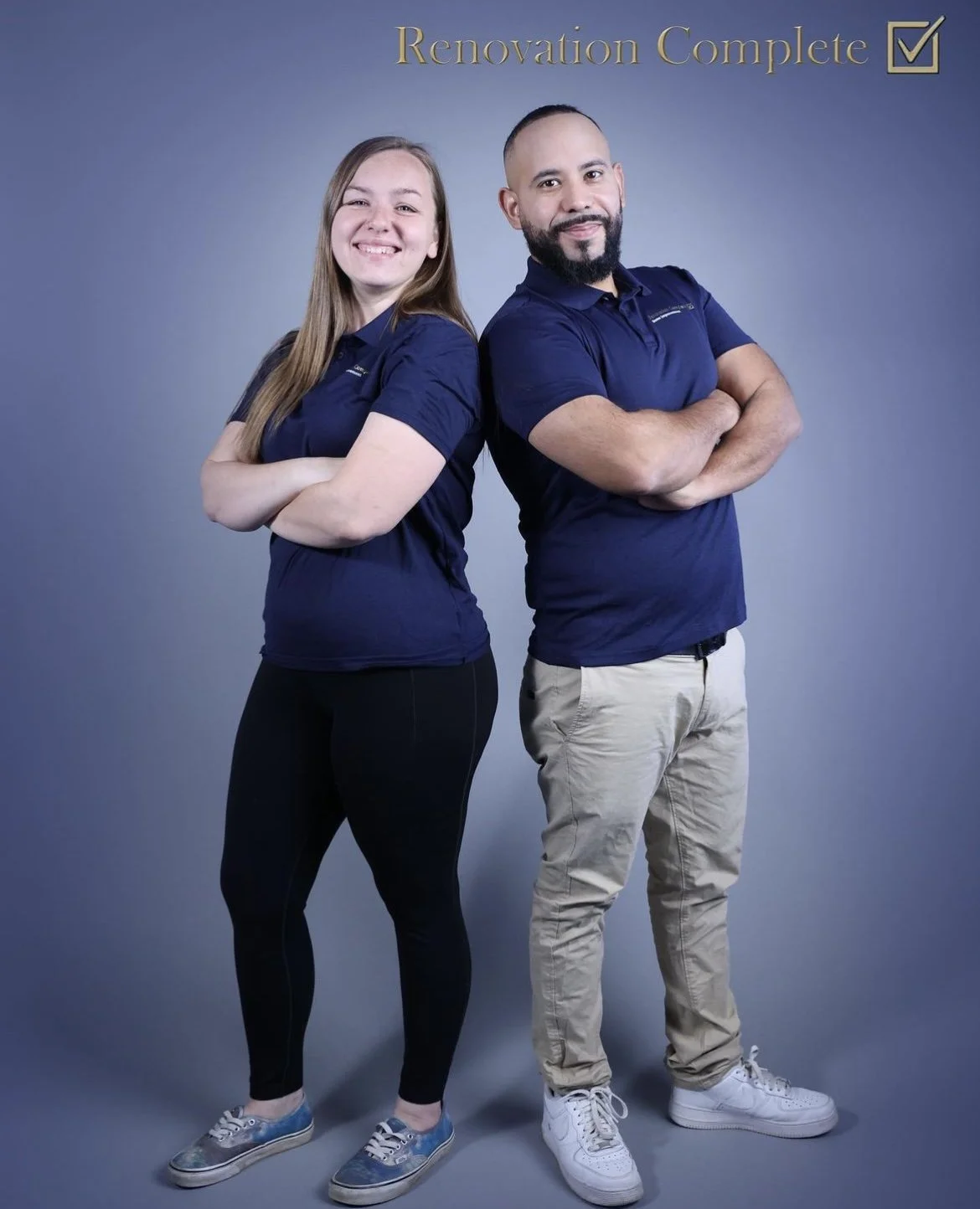 Two people standing back to back with arms crossed, smiling, with a gray background, and a gold text overlay that says 'Renovation Complete' with a check mark in the top right corner.