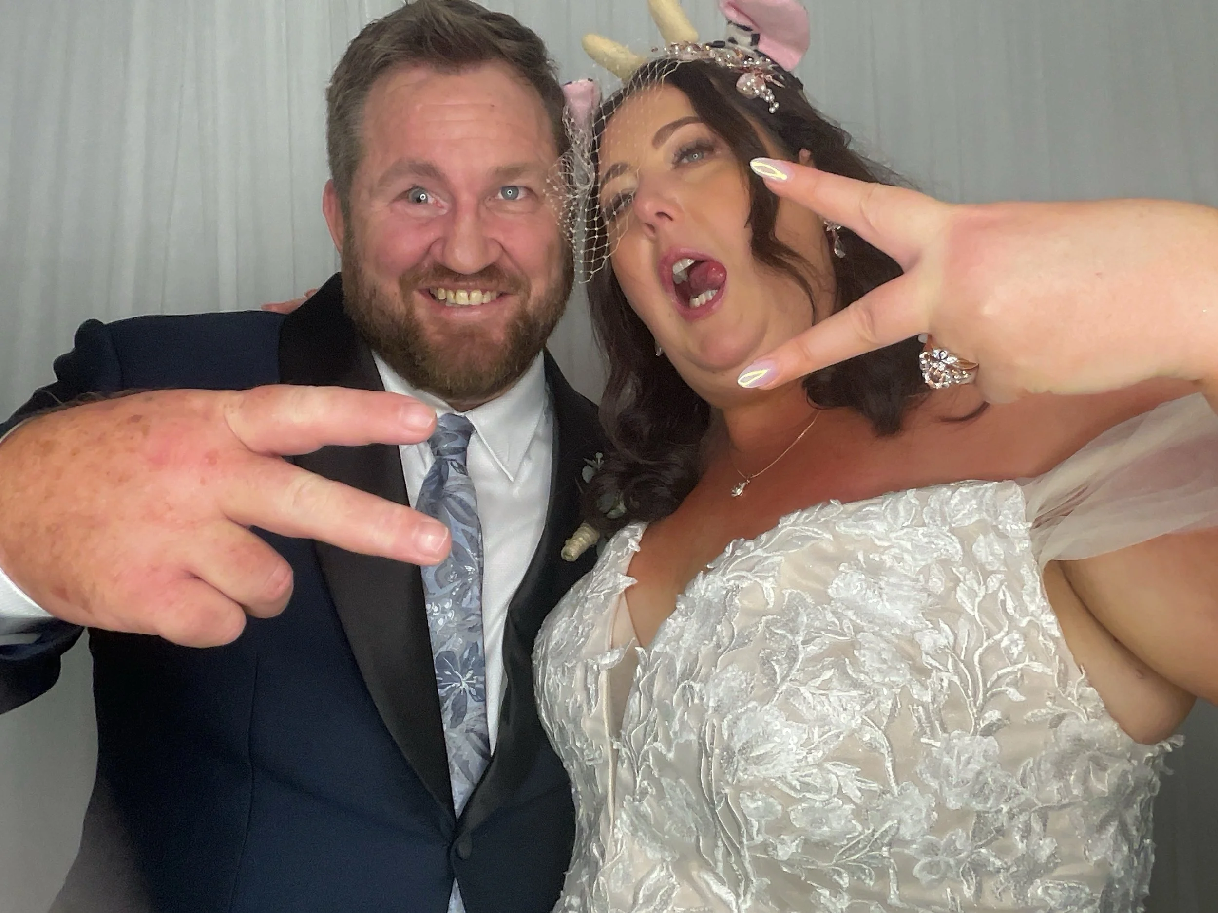 Cowbell Creek Wedding Venue - A bride in a white wedding gown smiles at her mother, who is wearing a pink dress, as they look at each other during a wedding preparation.