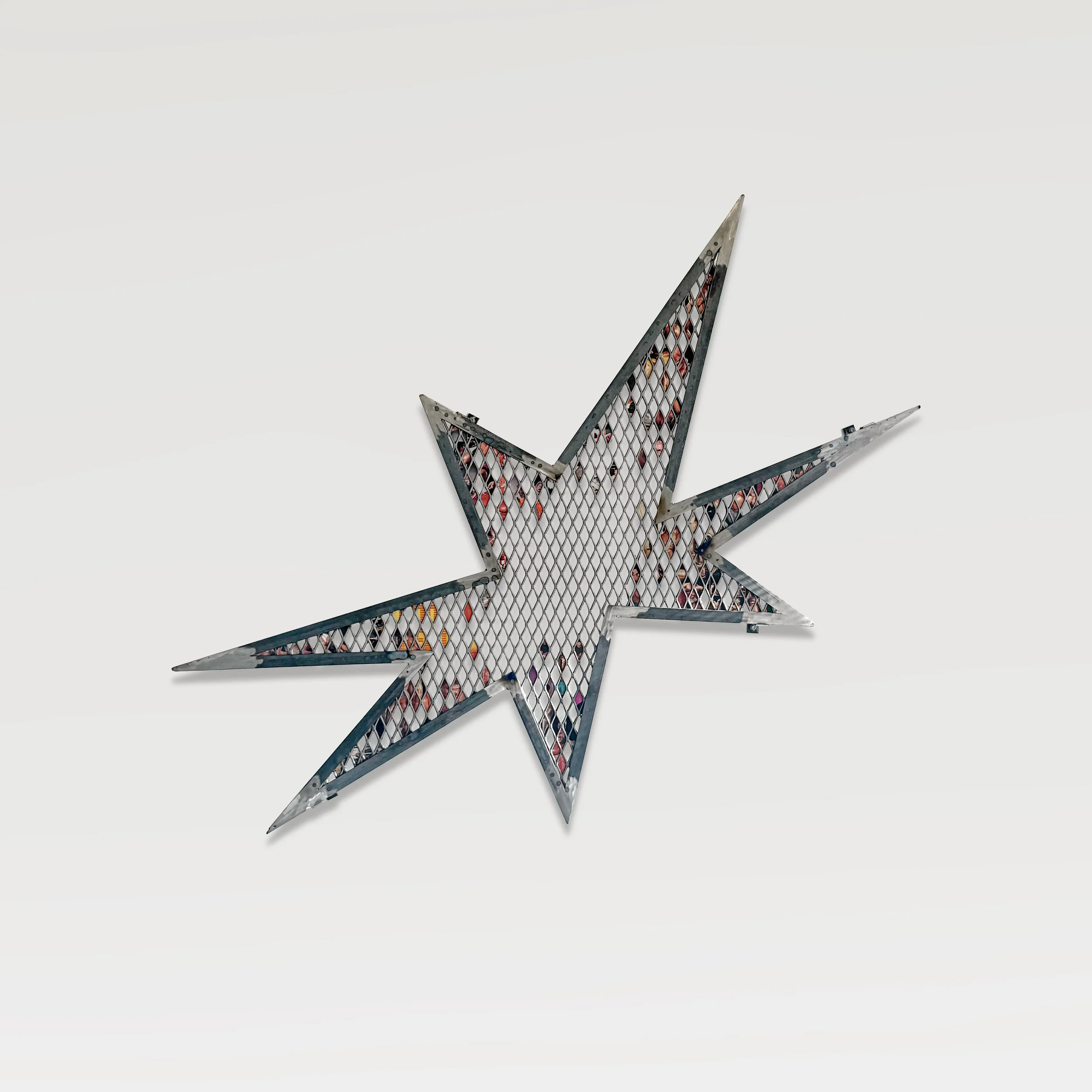 Put to Wrest (Bust Negative), 2026, Expanded metal sheet, mild steel, offset magazine print on coated paper, 37.5 in H × 64.5 in W  (95.3 × 163.8 cm)