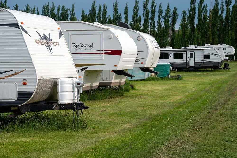 Lineup of Trailers Campers and RV's stored safely for the summer