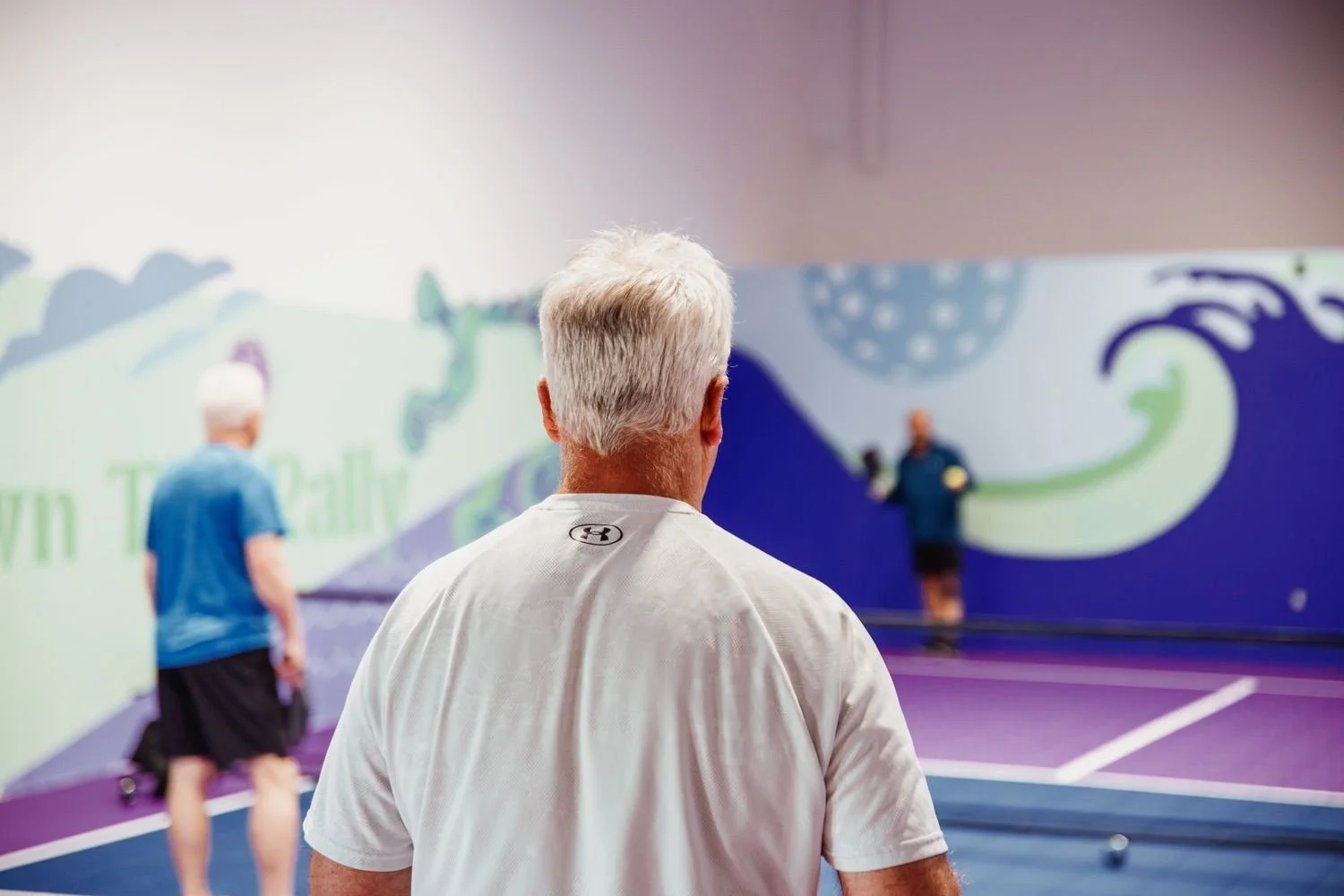 a man playing pickleball on an indoor court in Halifax