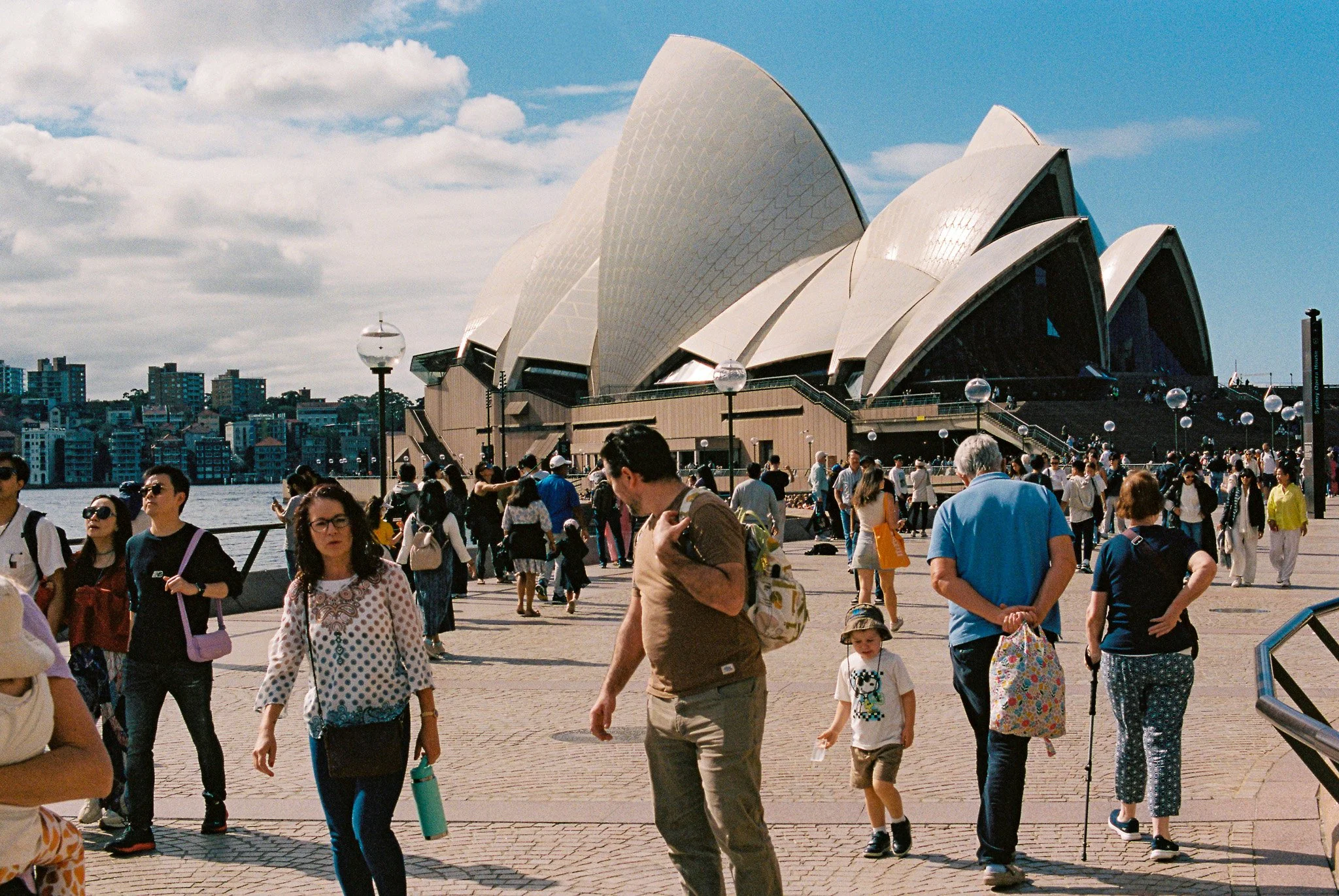 A 35mm film photo of the sydney opera house. Shot using a nikon f3 camera on kodak portra 400 film, high resolution scan by bright side film lab. Film developing australia-wide.