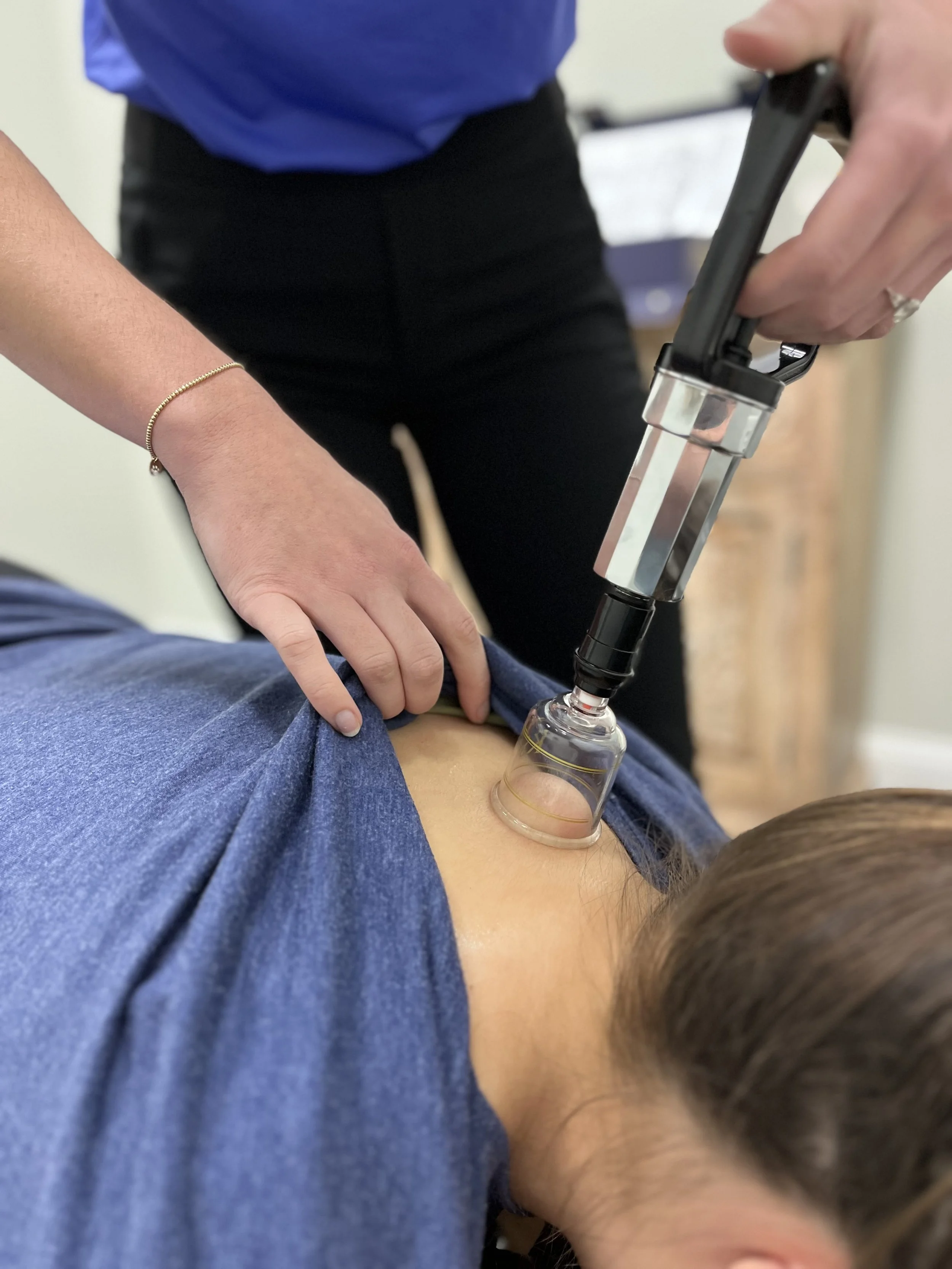A person receiving an injection or vaccination in their upper arm with a syringe, with another person administering it.