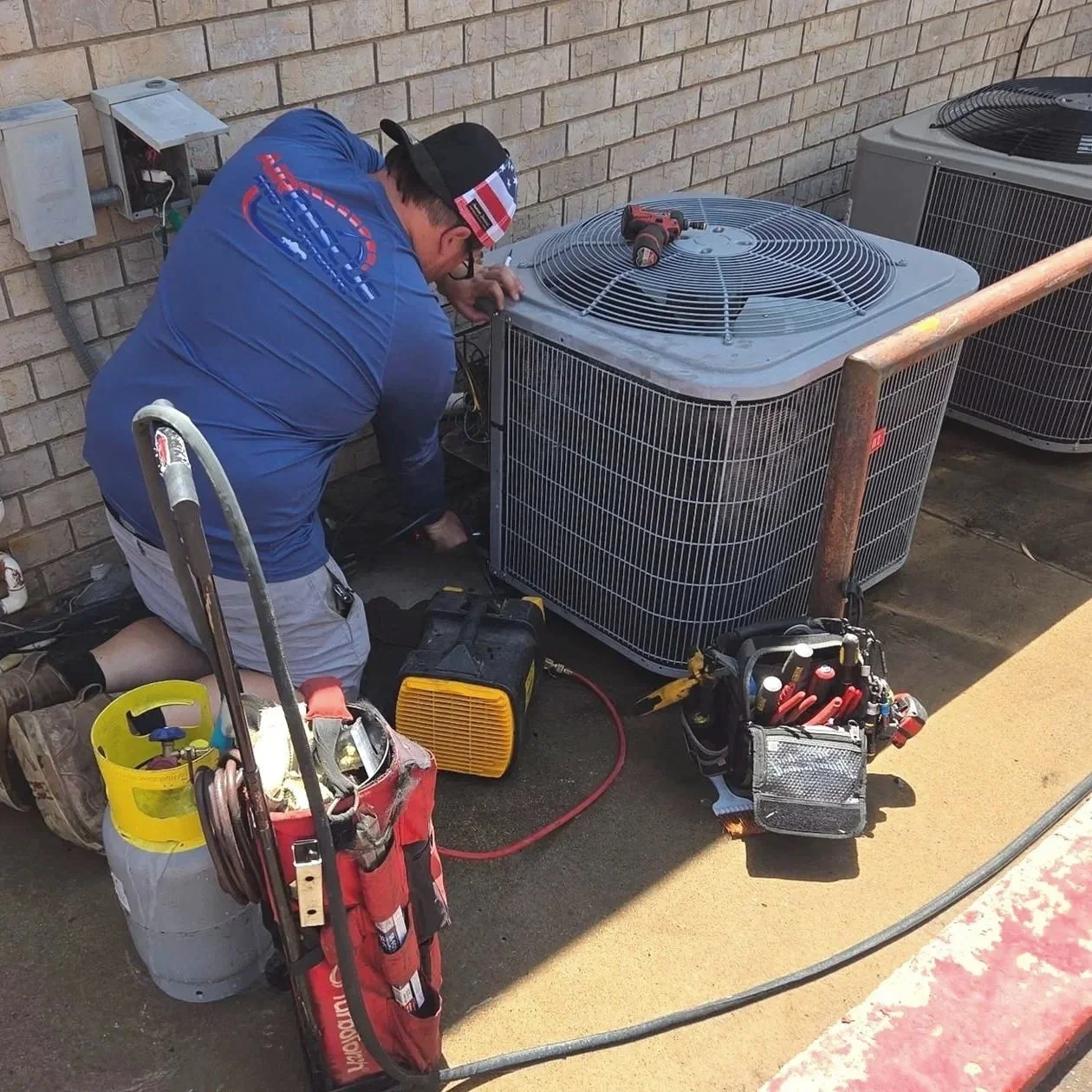 Air Rescue HVAC technician performing air conditioning repair on an outdoor AC unit in St. George, Utah.