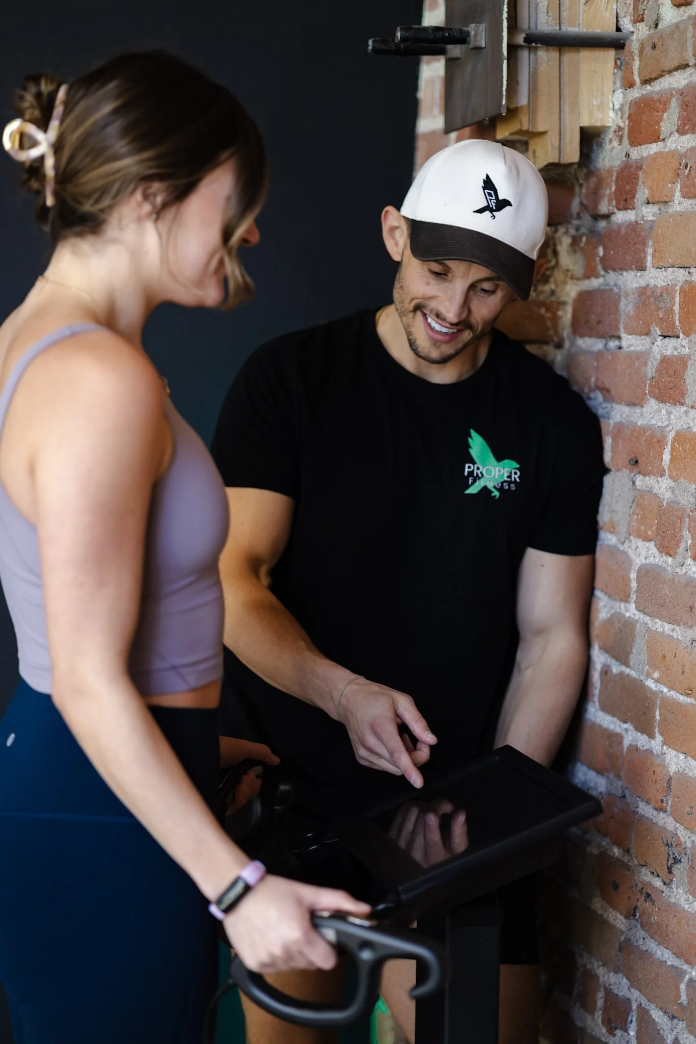 A personal trainer doing a fitness assessment and evolt body composition scan in denver