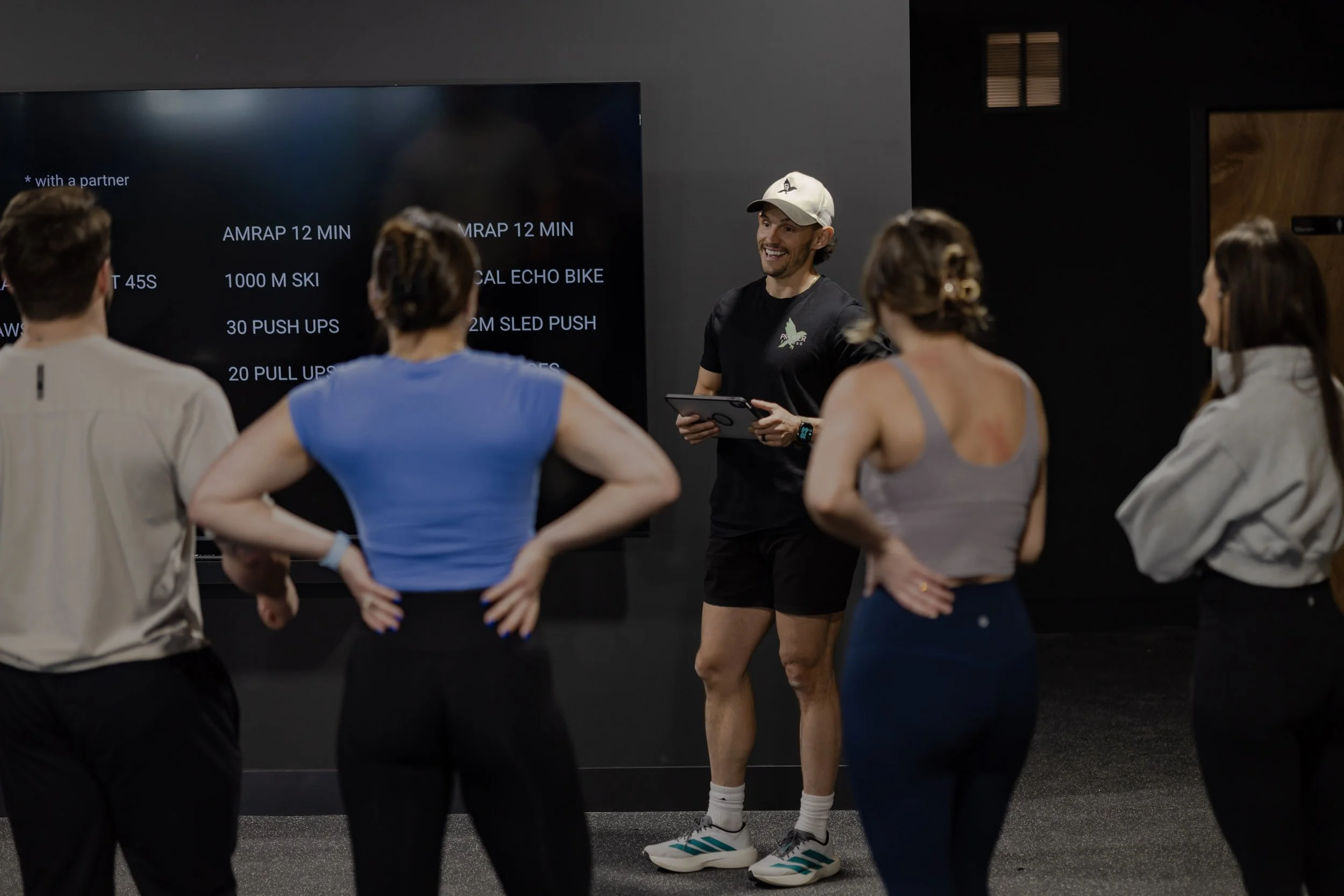 Fitness coach leading a semi-private training session at Proper Fitness personal training studio in Denver’s Santa Fe Arts District.