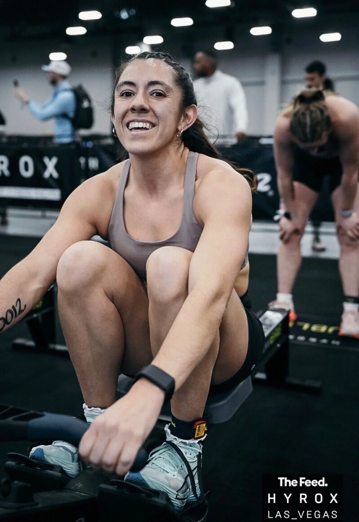 woman competing in a Hyrox race on a rower in Denver Colorado