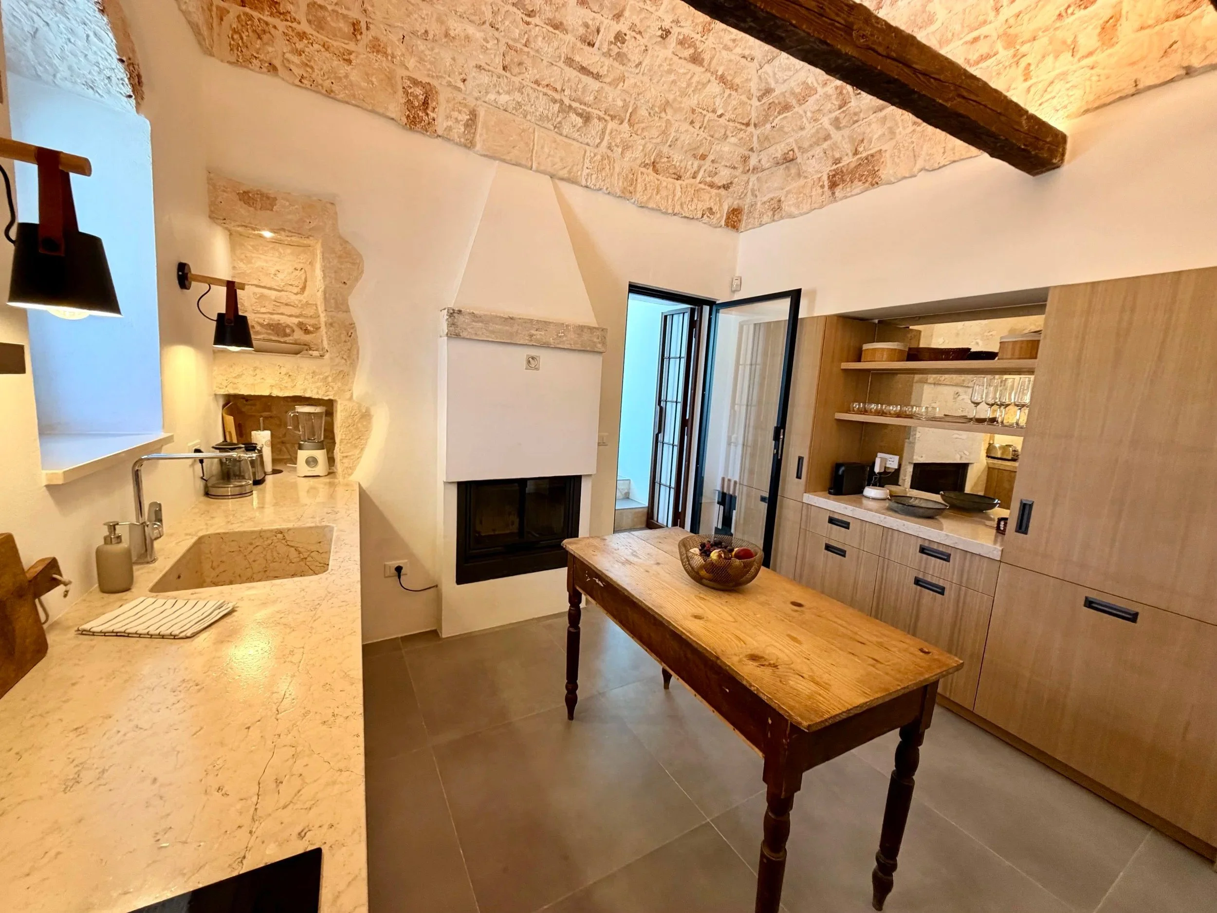 Kitchen beneath a whitewashed stone trullo dome at Trullo Ostro by Fable Retreats