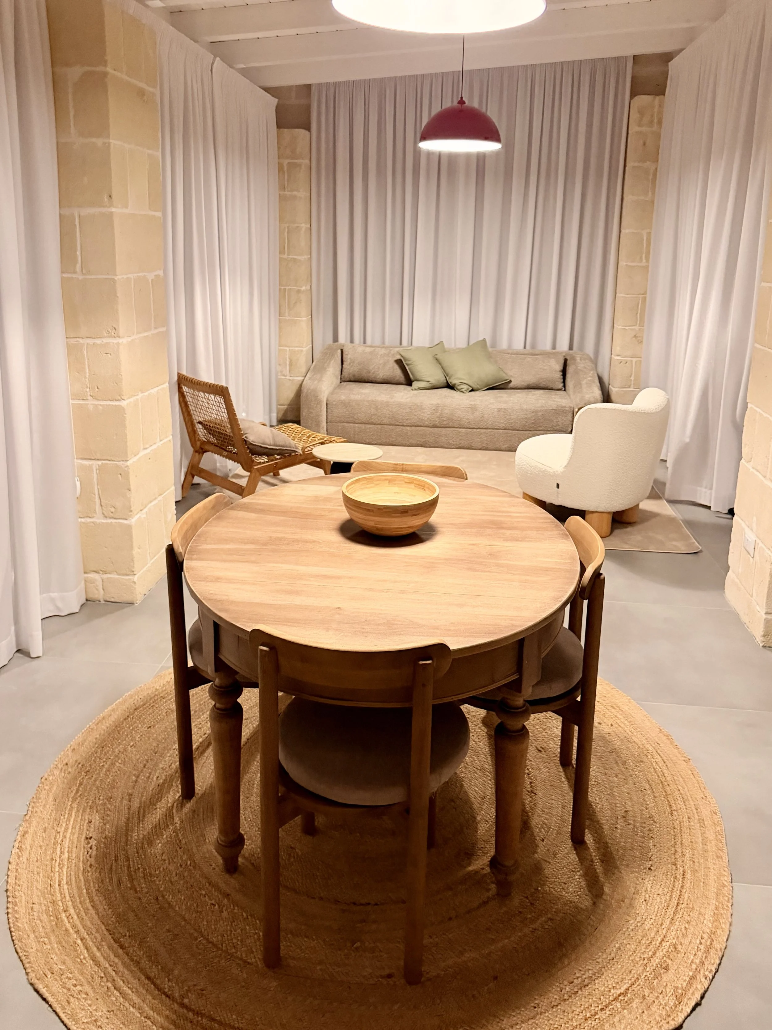 Round dining table and living room at Trullo Ostro