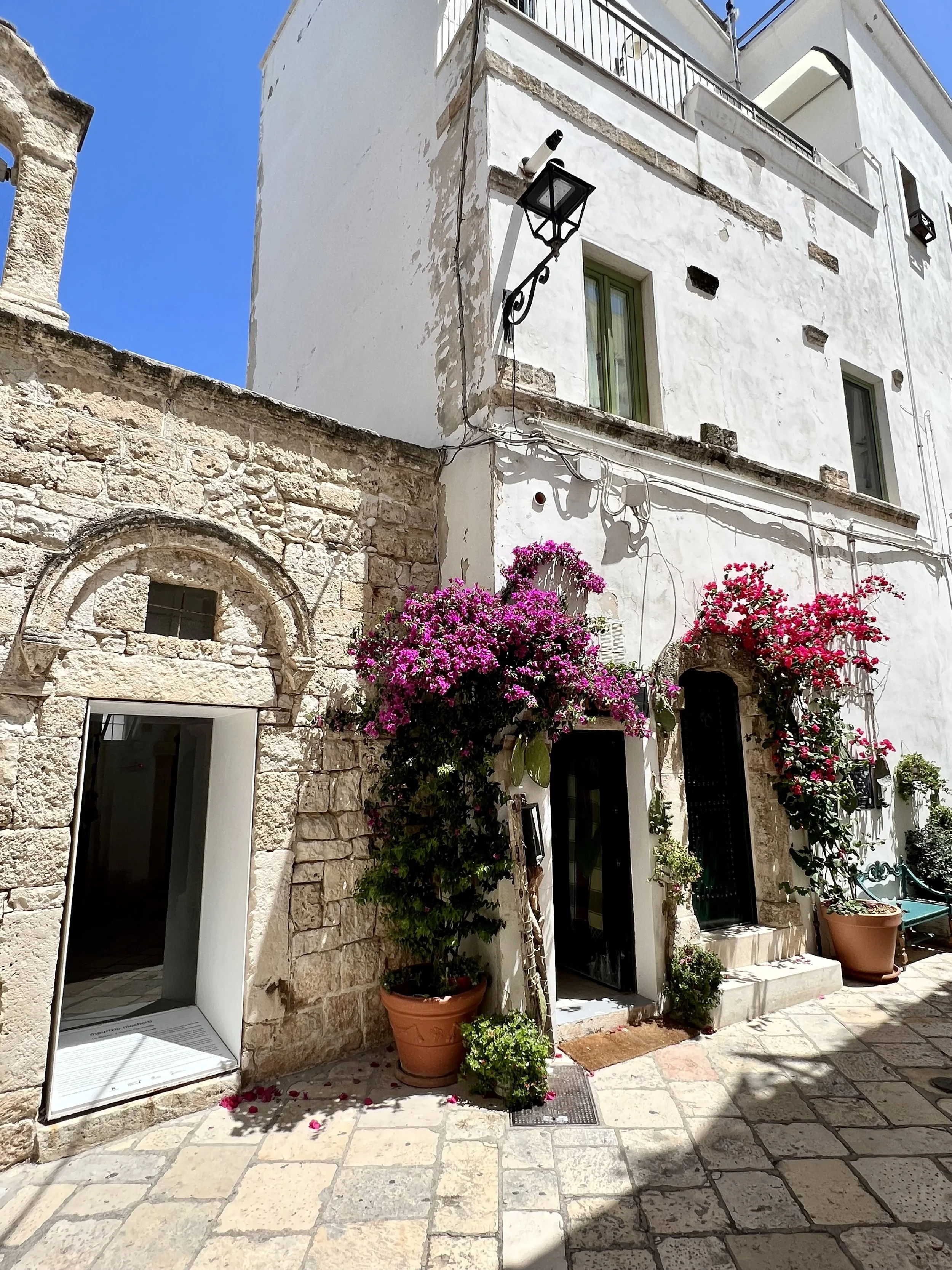 Stone doorway with pink bougainvillea in a Puglia village