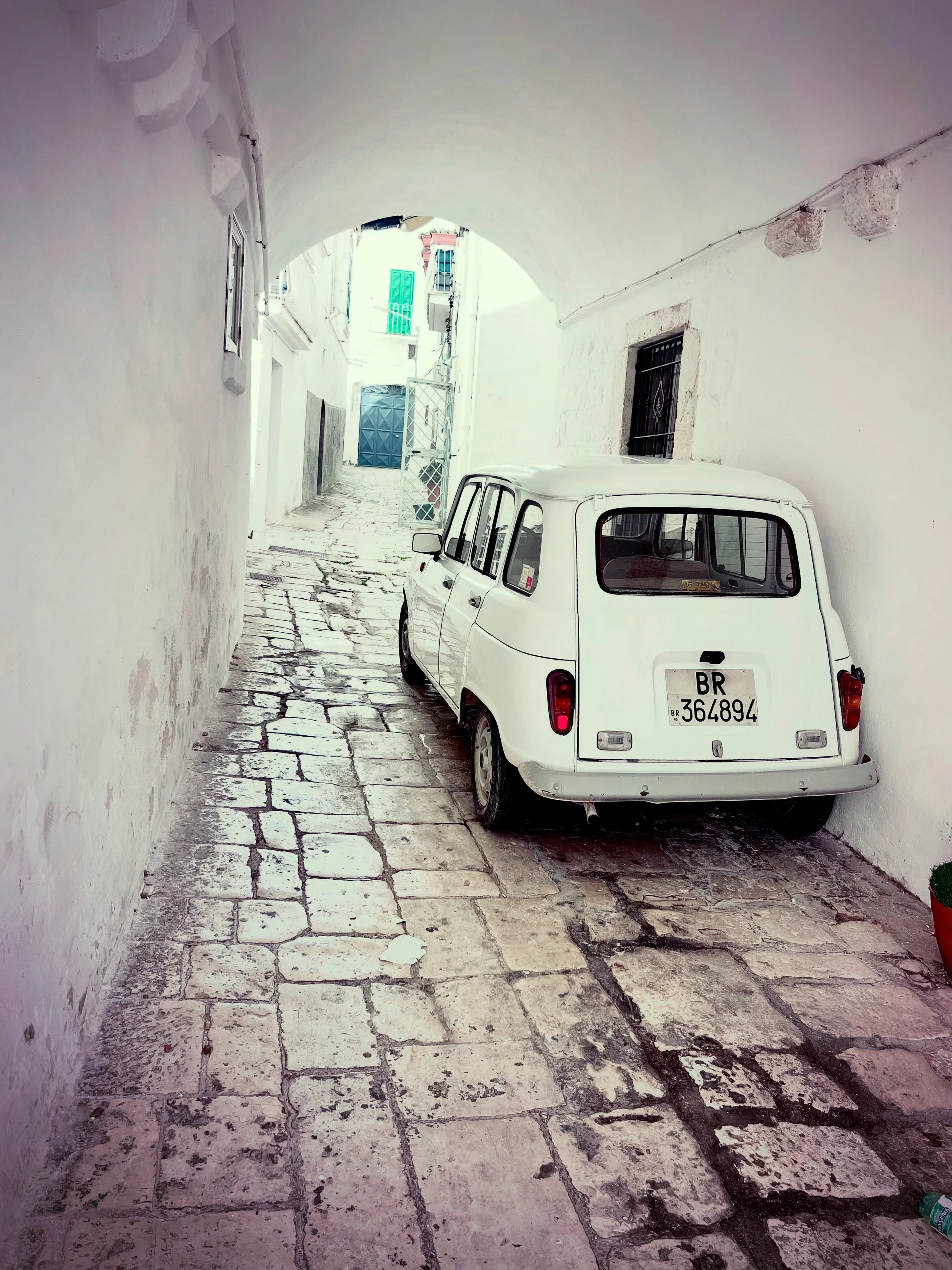 Vintage white car in a whitewashed alley in Puglia