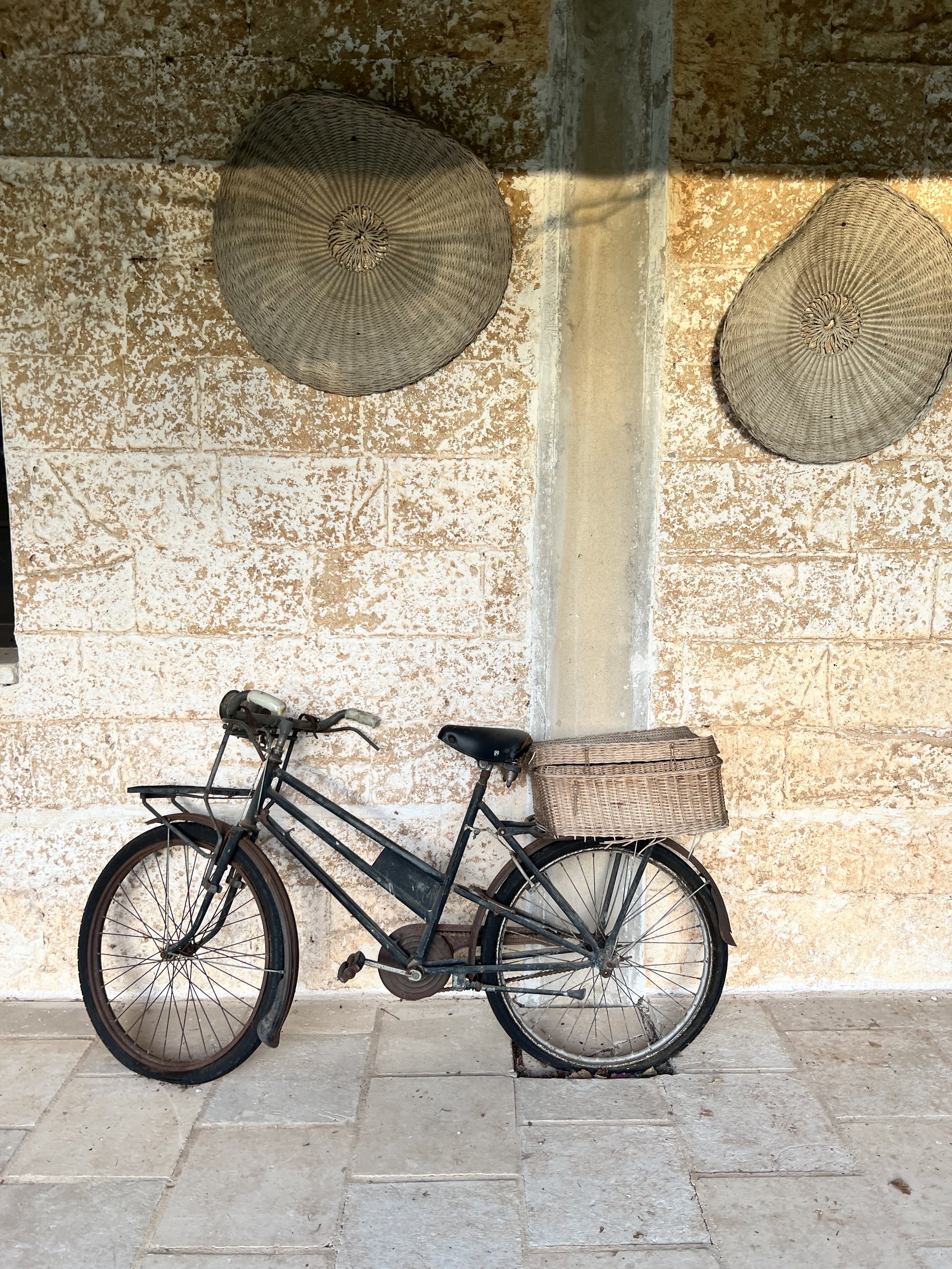 Vintage bicycle against a limestone wall in Puglia