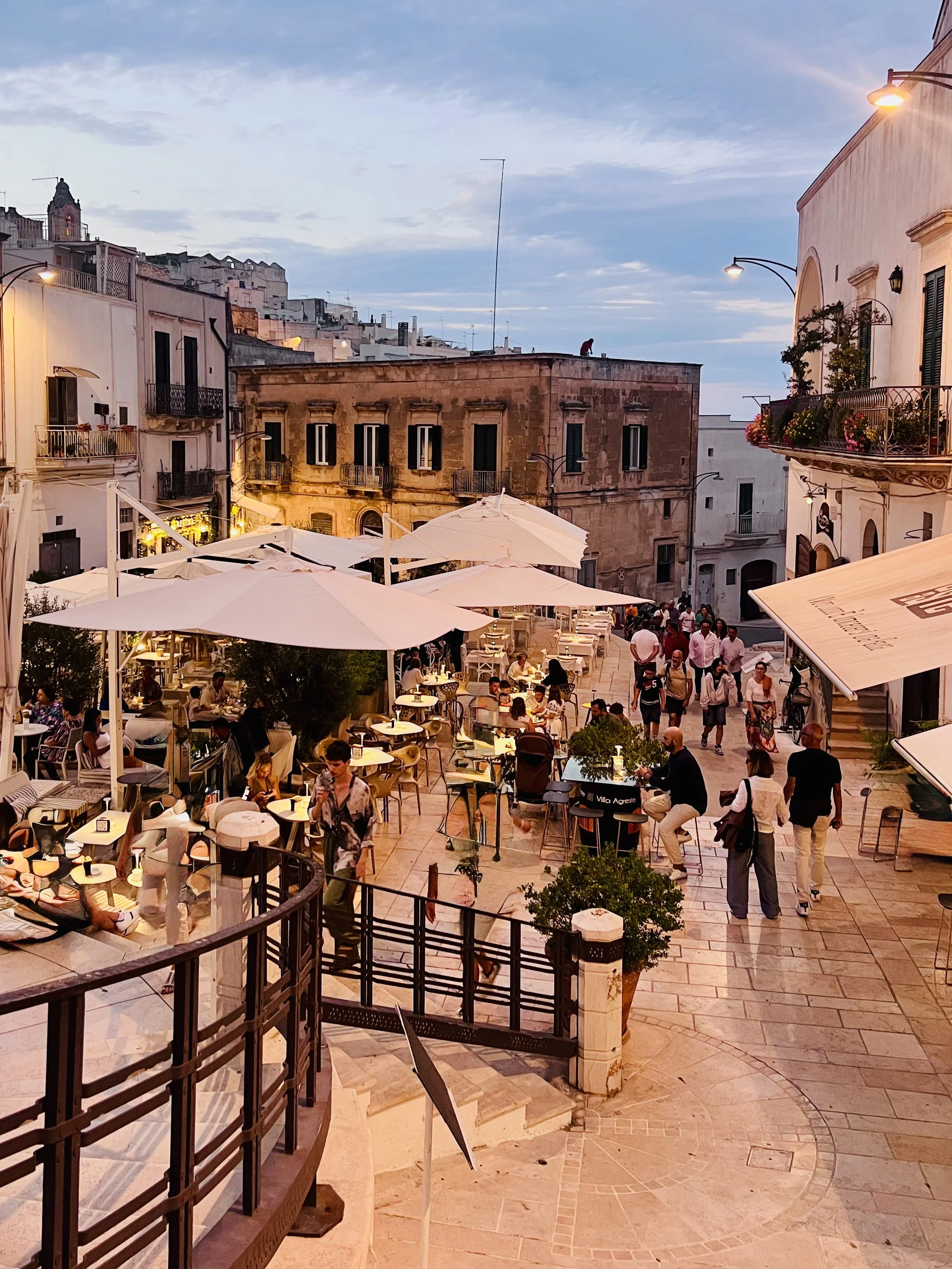 Outdoor cafés in a Puglia piazza near Trullo Ostro