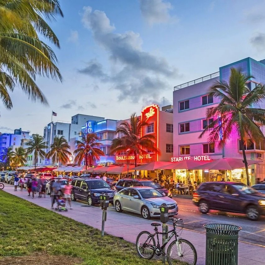 Art Deco hotels lit up at dusk on Ocean Drive, South Beach, Miami