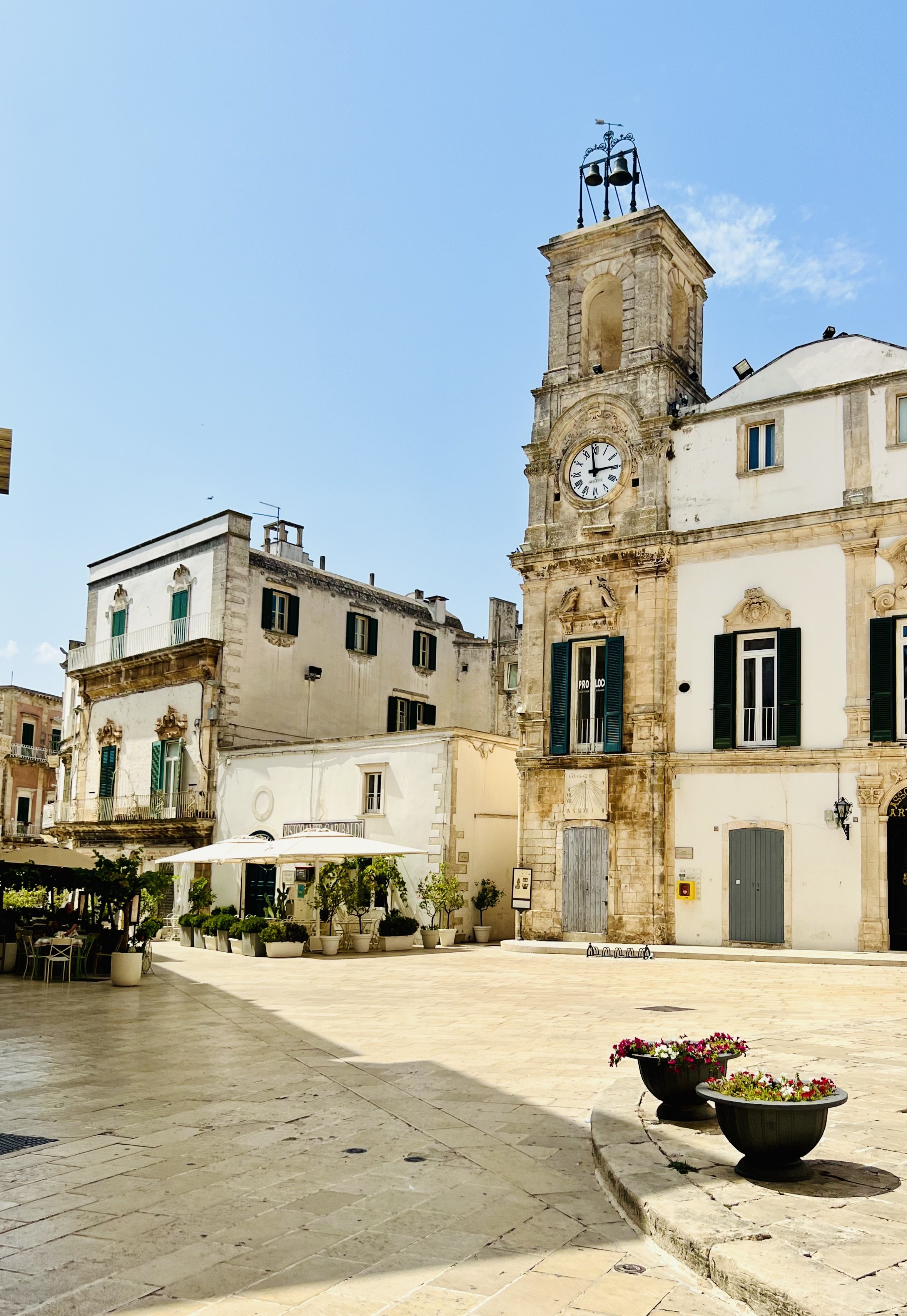 Clock tower and palazzi in a Puglia town square