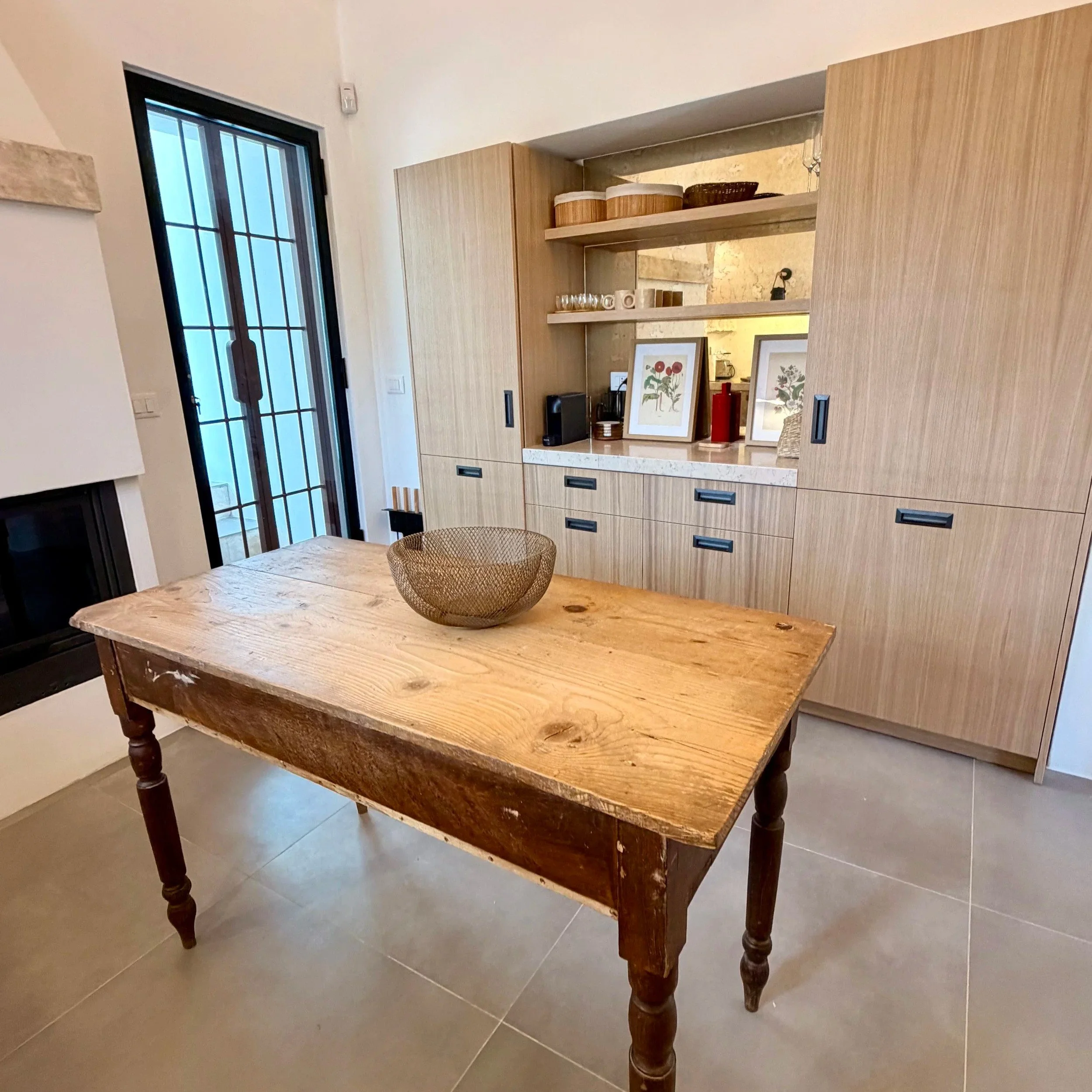 Rustic wooden dining table in the kitchen at Trullo Ostro, Puglia
