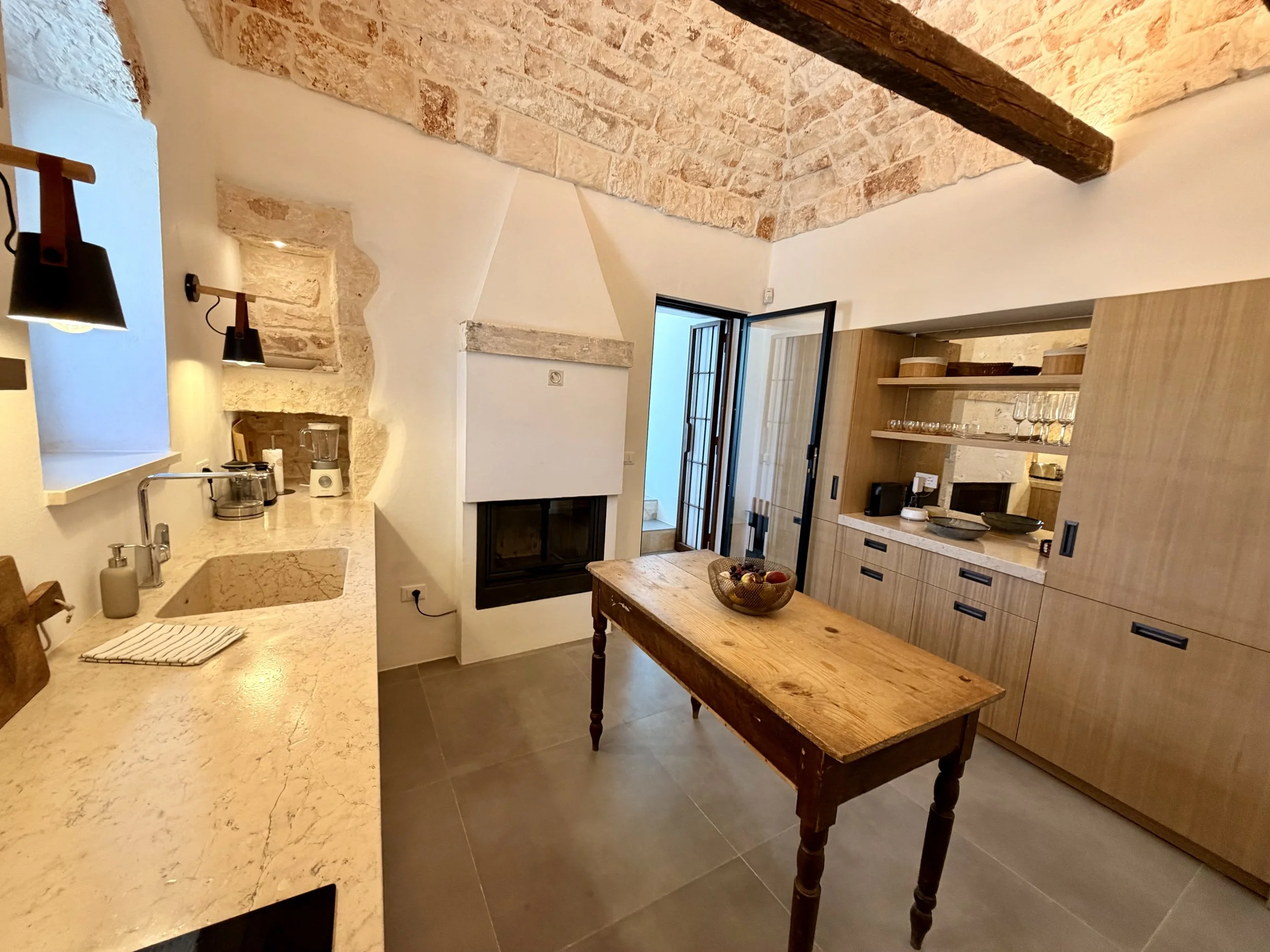 Kitchen under a stone trullo ceiling at Trullo Ostro