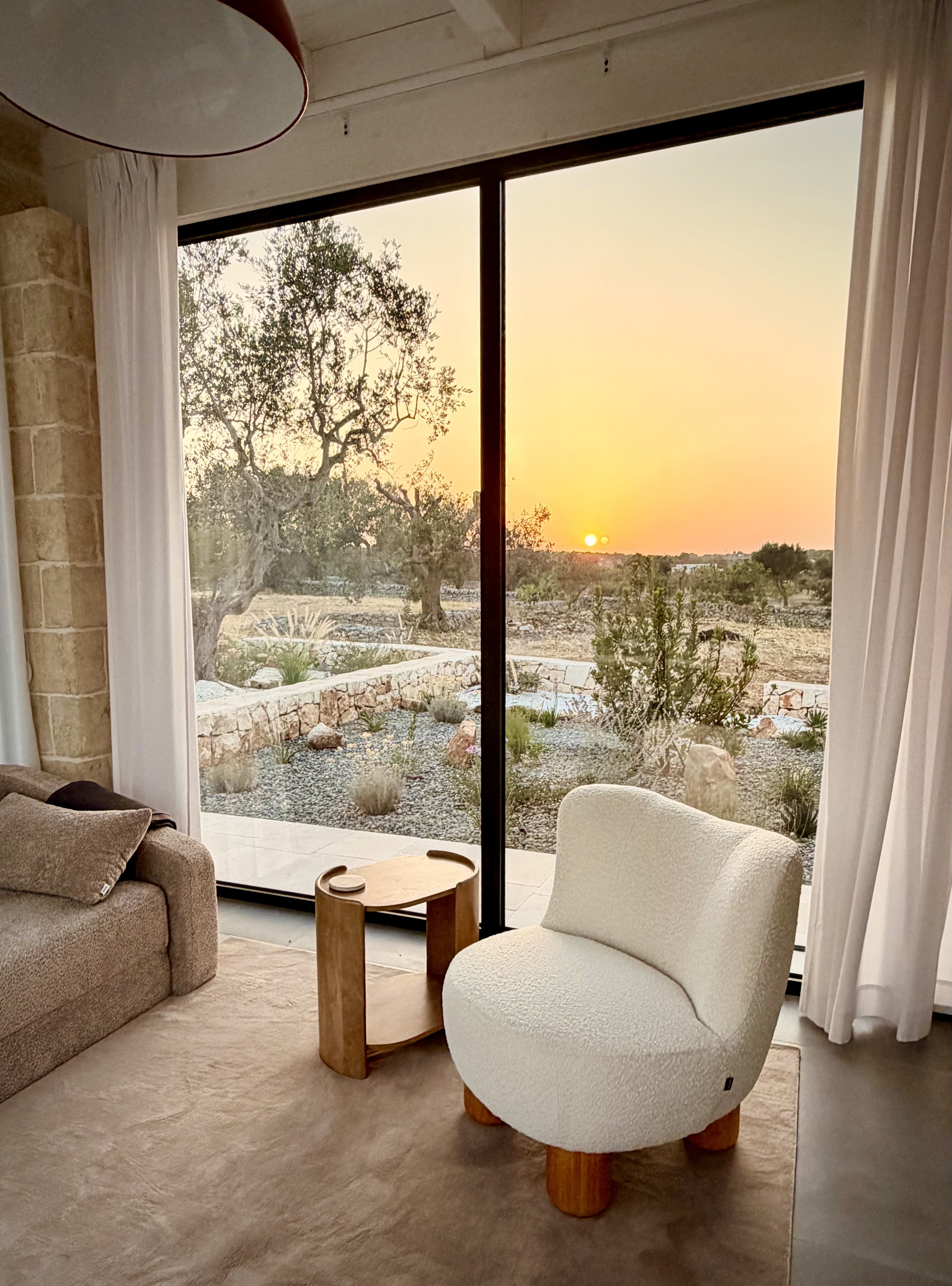 Sunset over the olive grove from the living room at Trullo Ostro