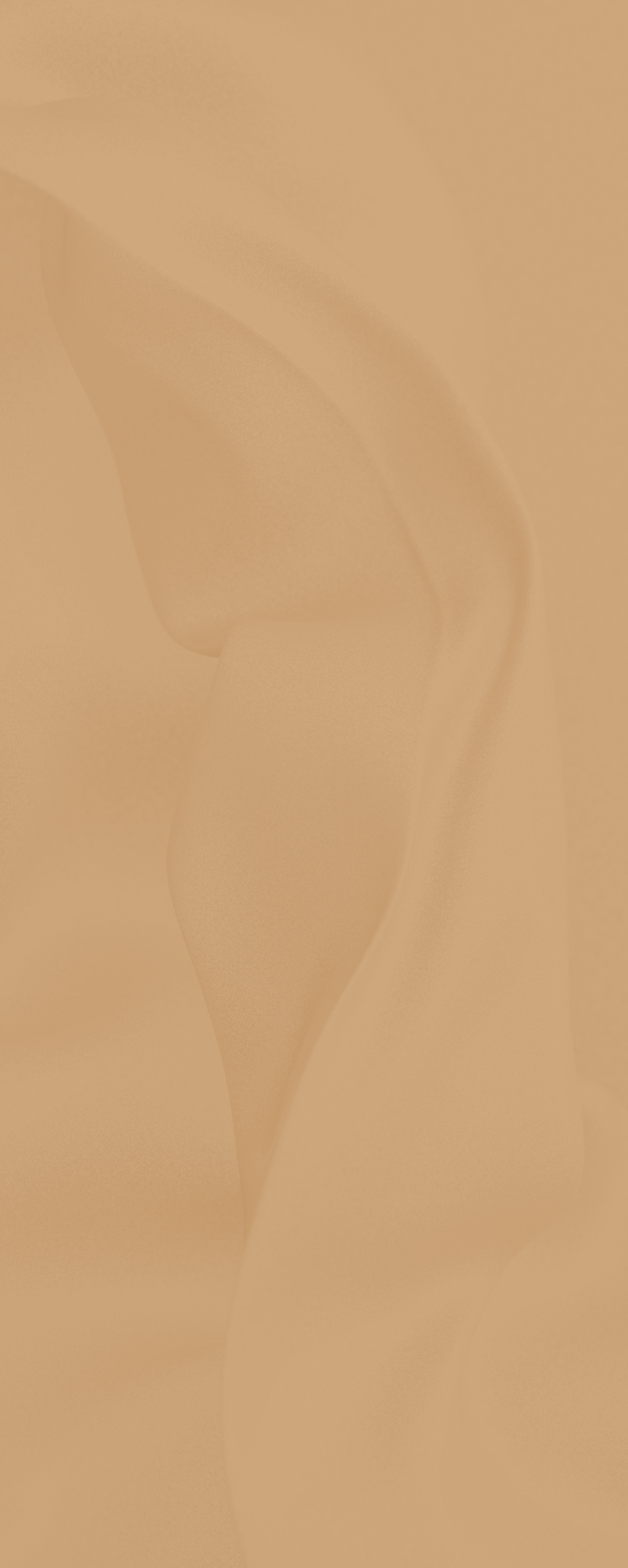 Close-up of smooth, curved beige or sand-colored textured surface with subtle shadowing.