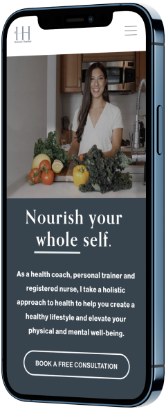 A smartphone displaying a health coaching website with a smiling woman in a white shirt behind a kitchen counter with vegetables, promoting a holistic approach to health.