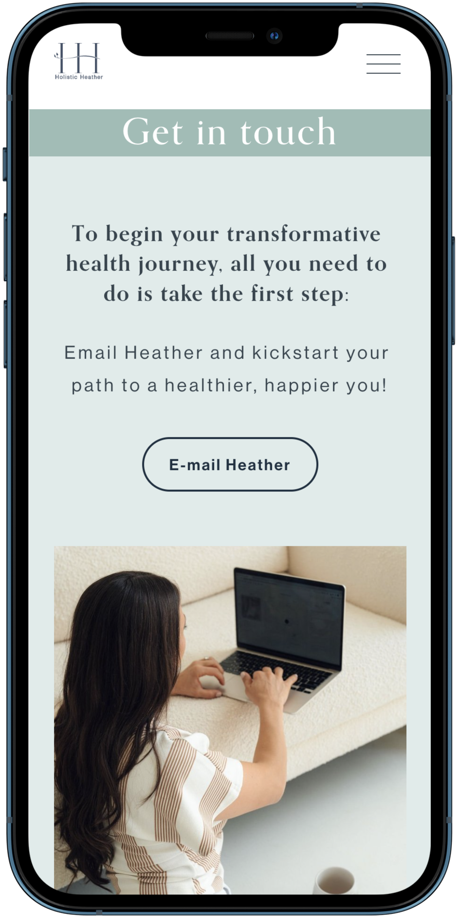 Mobile website with a 'Get in touch' page featuring a logo for Holistic Heather, text encouraging contact via email to start a health journey, a contact button labeled 'E-mail Heather', and an image of a woman with long dark hair using a laptop on a couch.