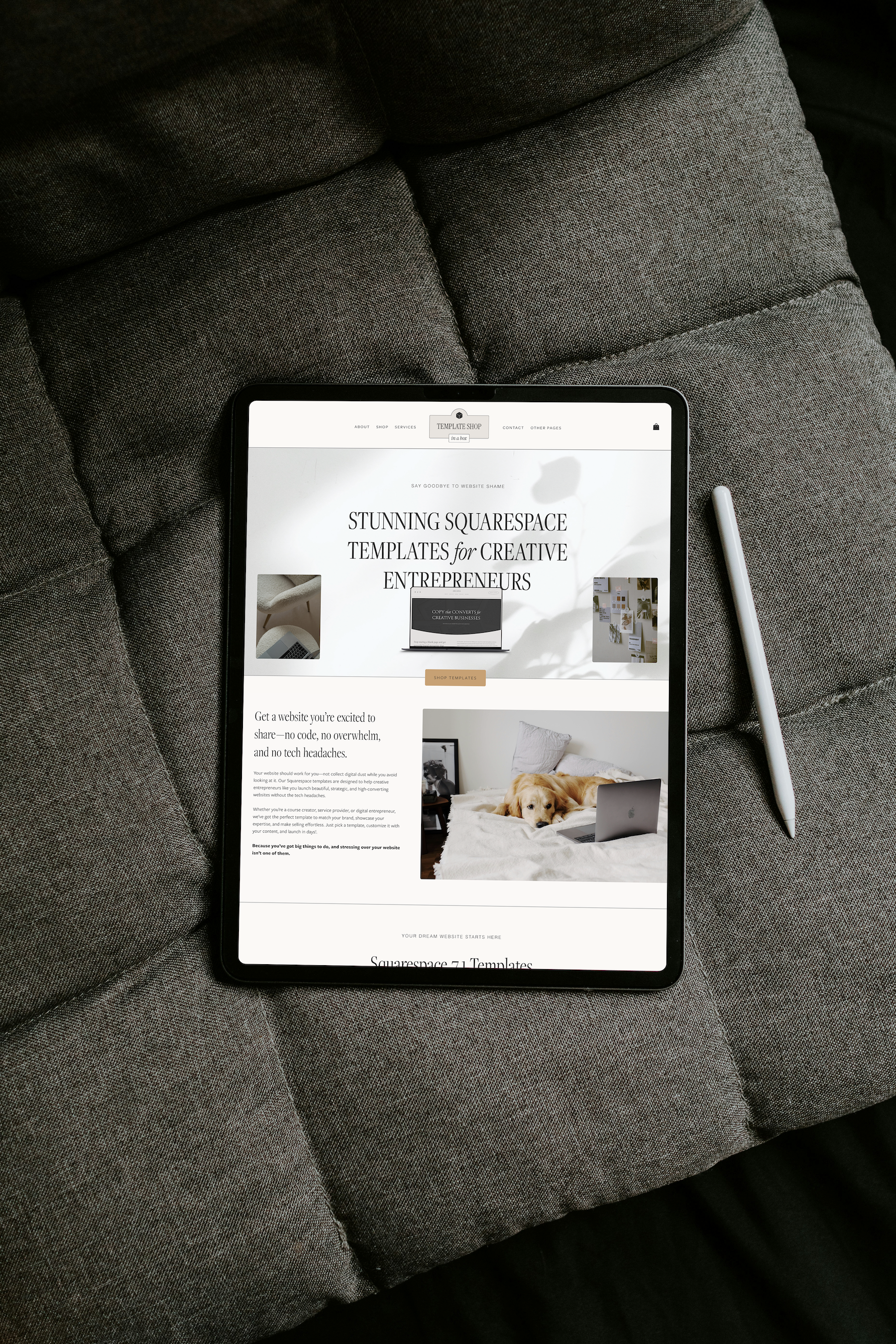 A tablet displaying a website about creative templates, lying on a gray fabric couch with a white stylus nearby.