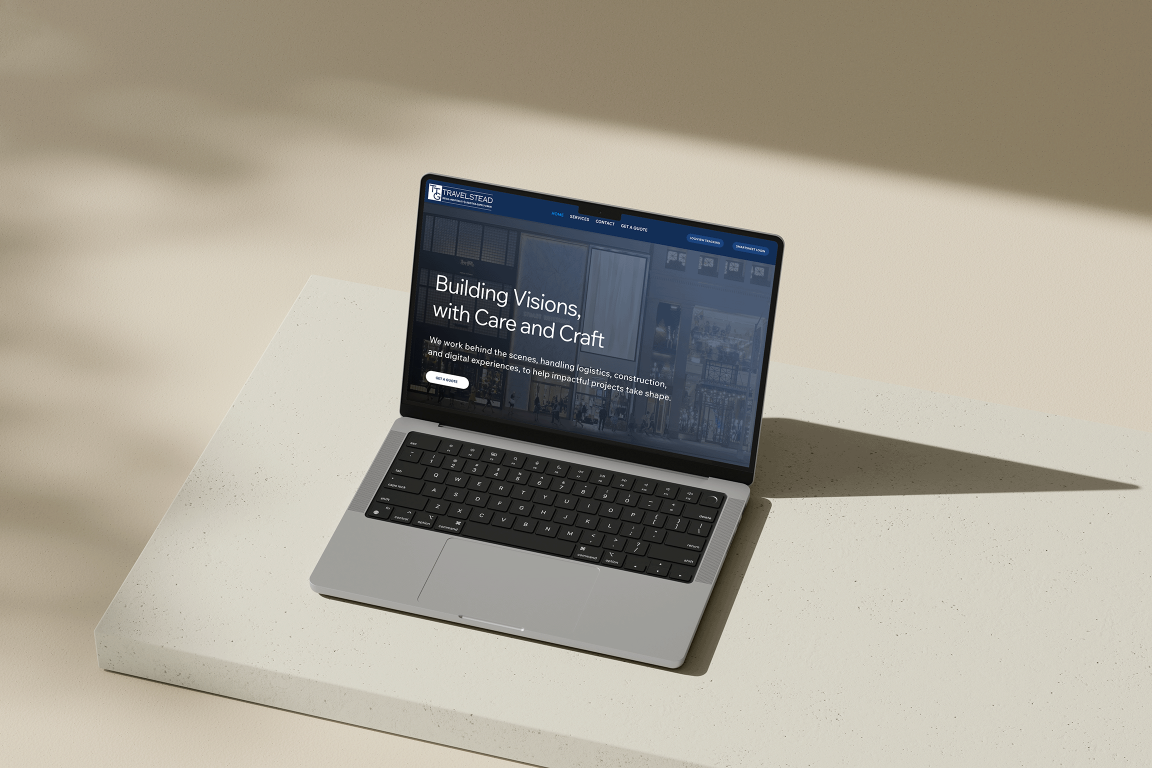 Open laptop computer with a website displayed, resting on a white surface against a beige background, casting a shadow.