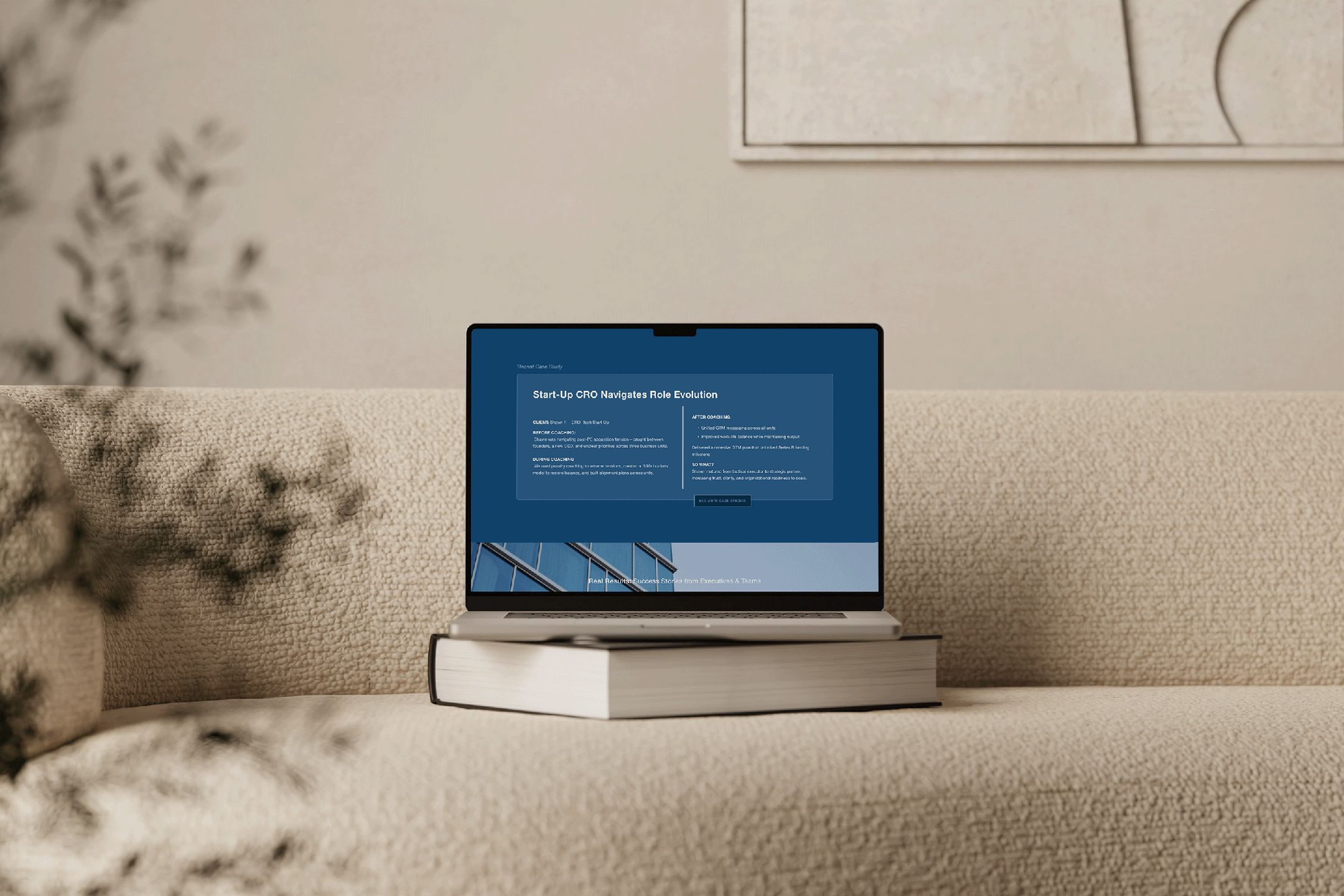 Laptop on top of a closed book on a beige sofa, displaying a webpage about startup CRO role evolution.