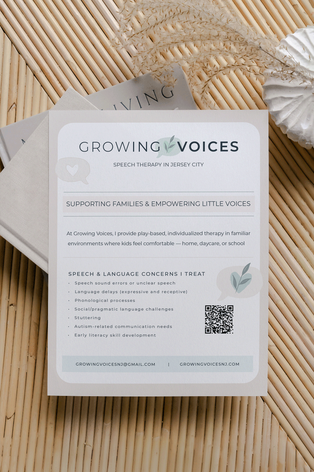 Brochure for Growing Voices, speech therapy services in Jersey City, supporting families and empowering children with speech and language needs, with contact email and website, placed on a wooden surface along with decorative dried grasses and a white ceramic vase.