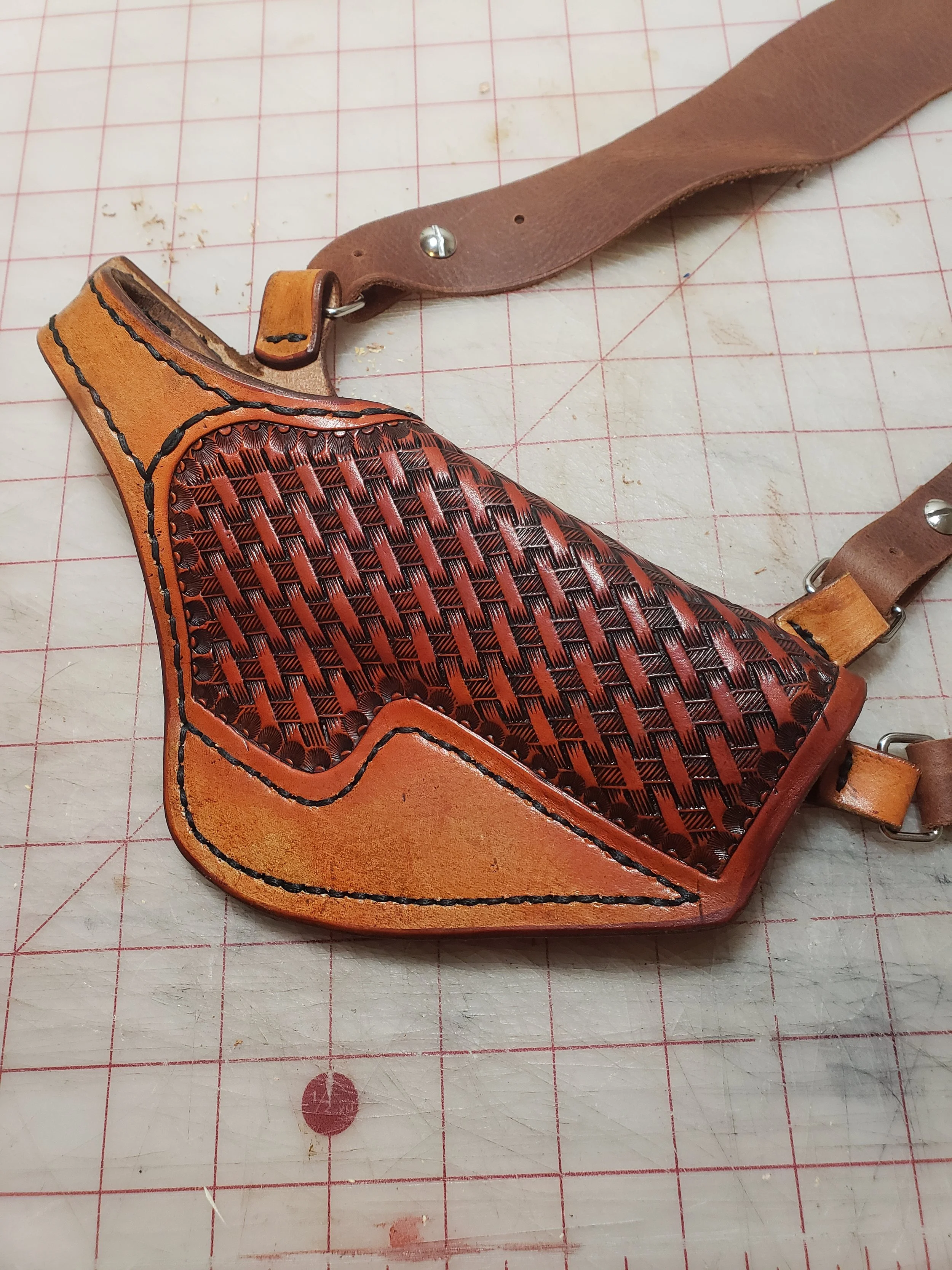 Custom designed, hand-made, leather holster with thumb-break.  Traditional basketweave pattern tooled into leather