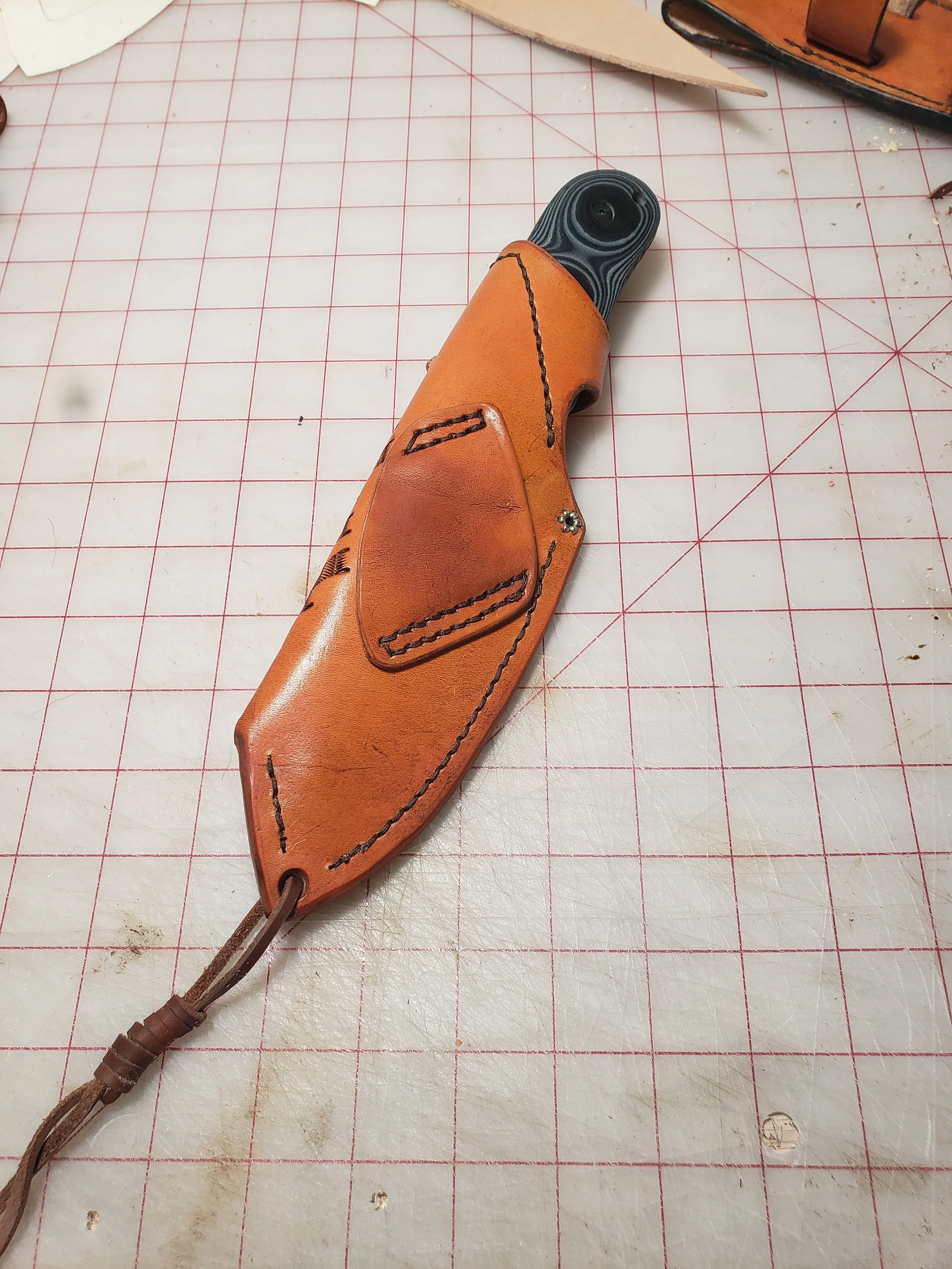 Backside of a custom-made leather sheath designed for off-side cross-draw